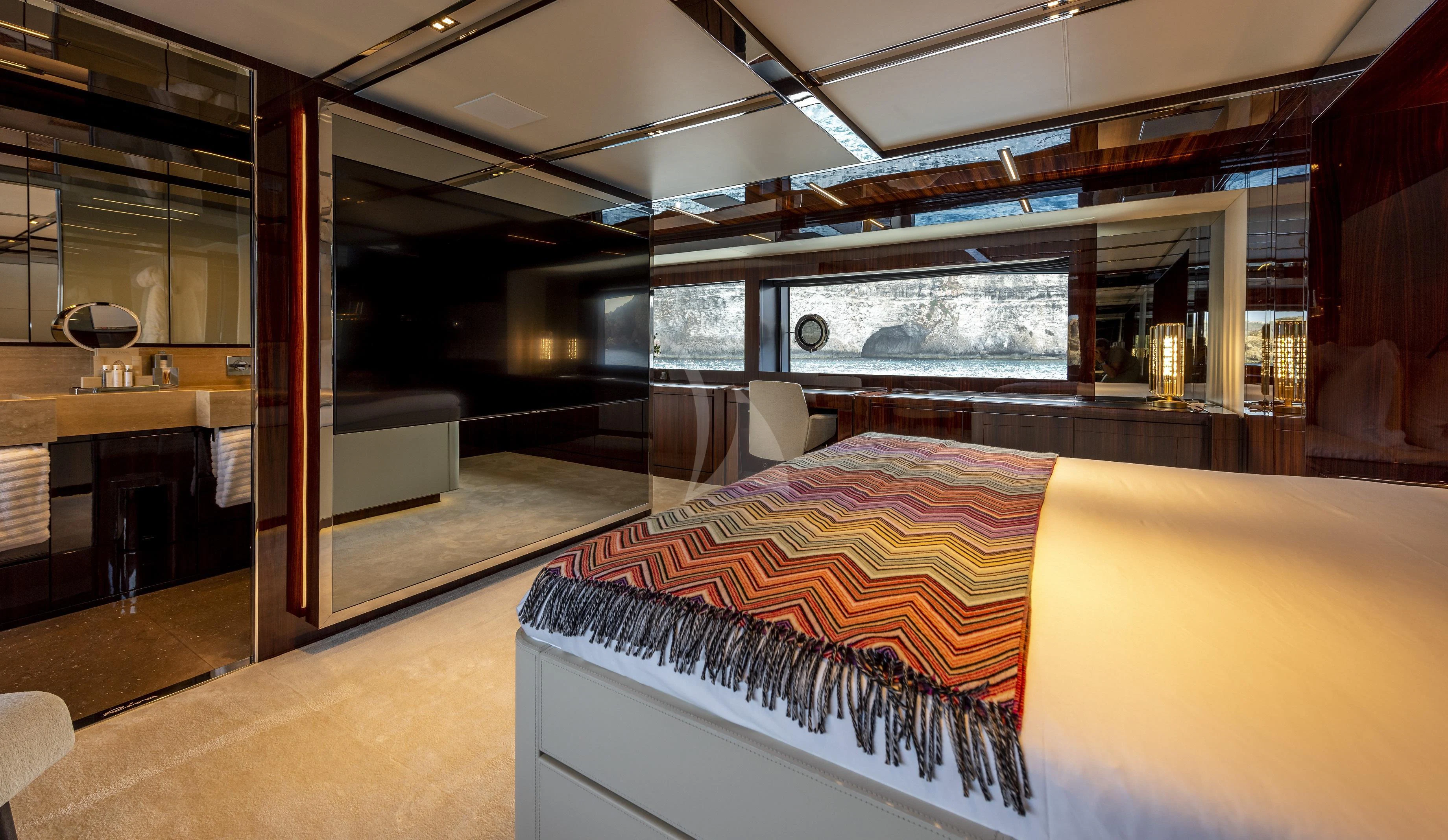 a room with a bed and a table aboard FIGURATI Yacht for Sale