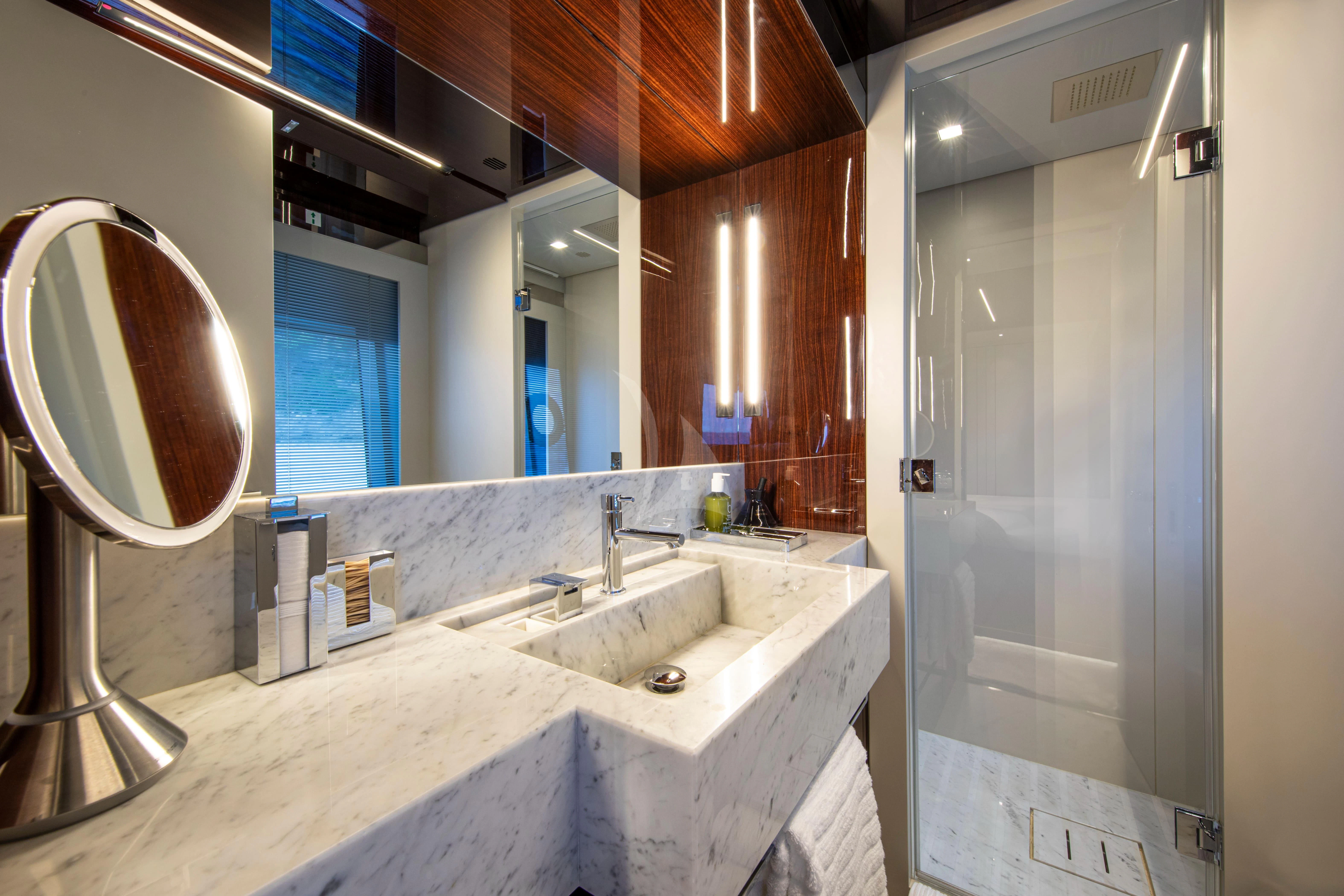 a bathroom with sinks and mirrors aboard FIGURATI Yacht for Sale