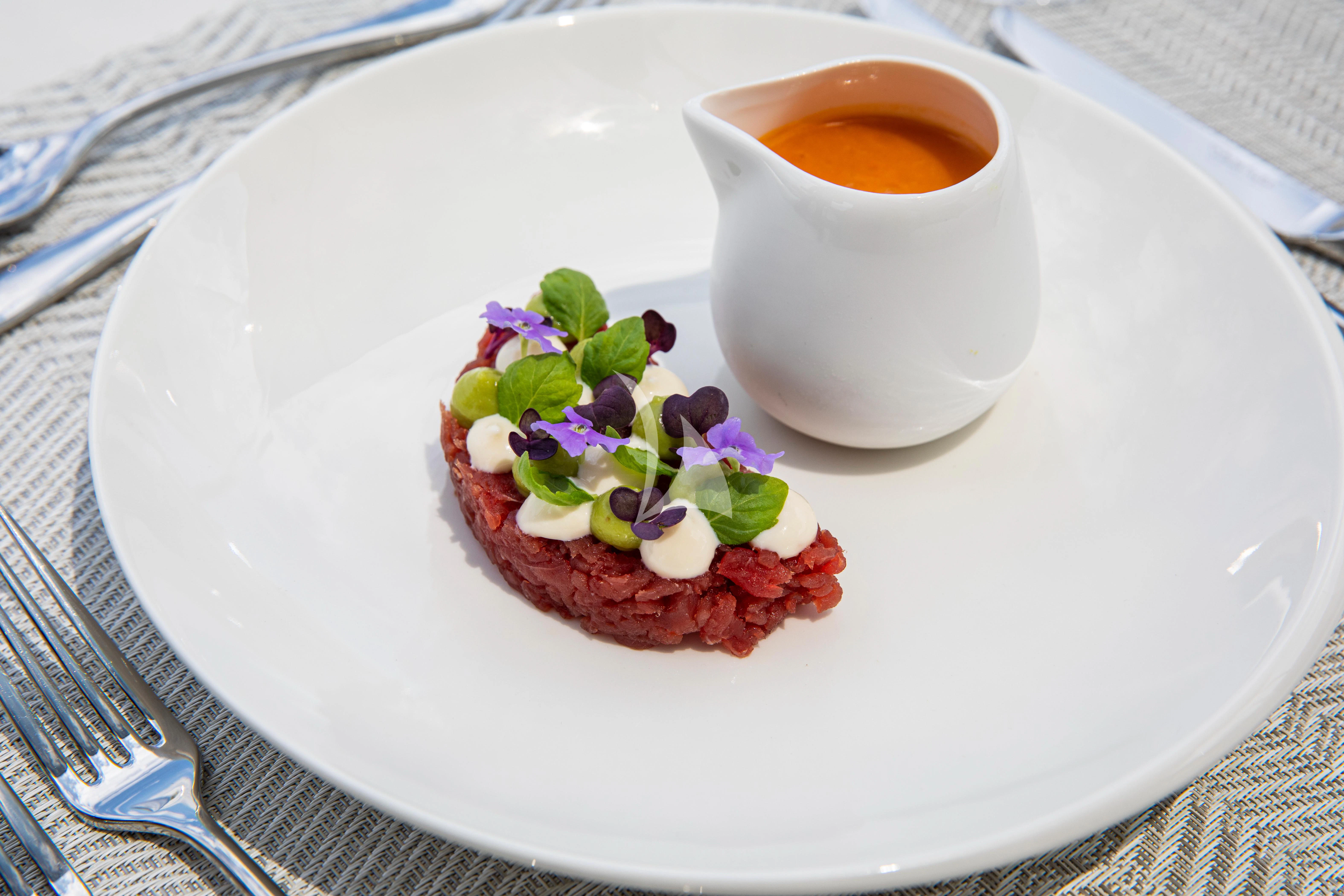 a plate with a cup of tea and a plate of food aboard FIGURATI Yacht for Sale