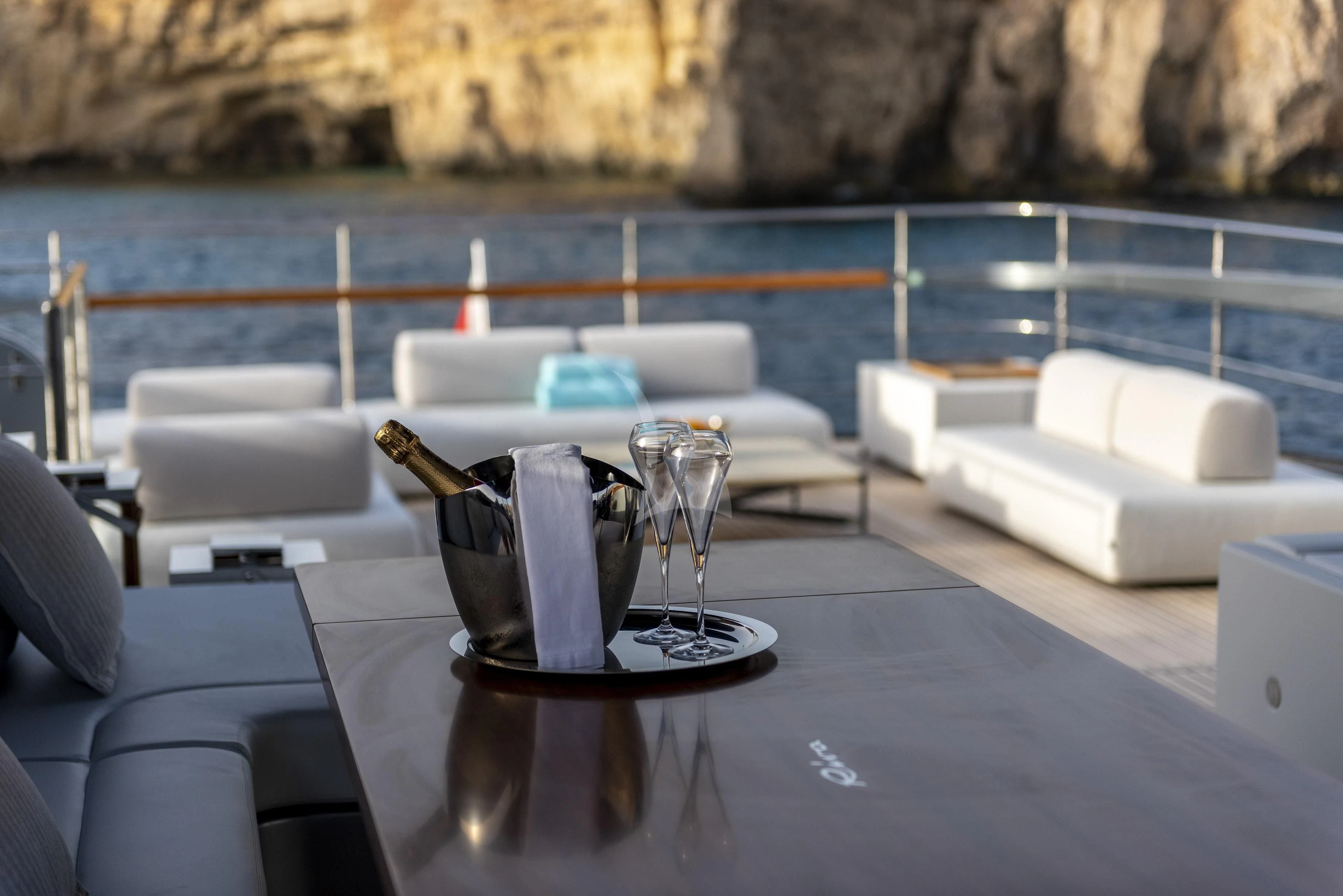 a table with chairs and a glass on it aboard FIGURATI Yacht for Sale
