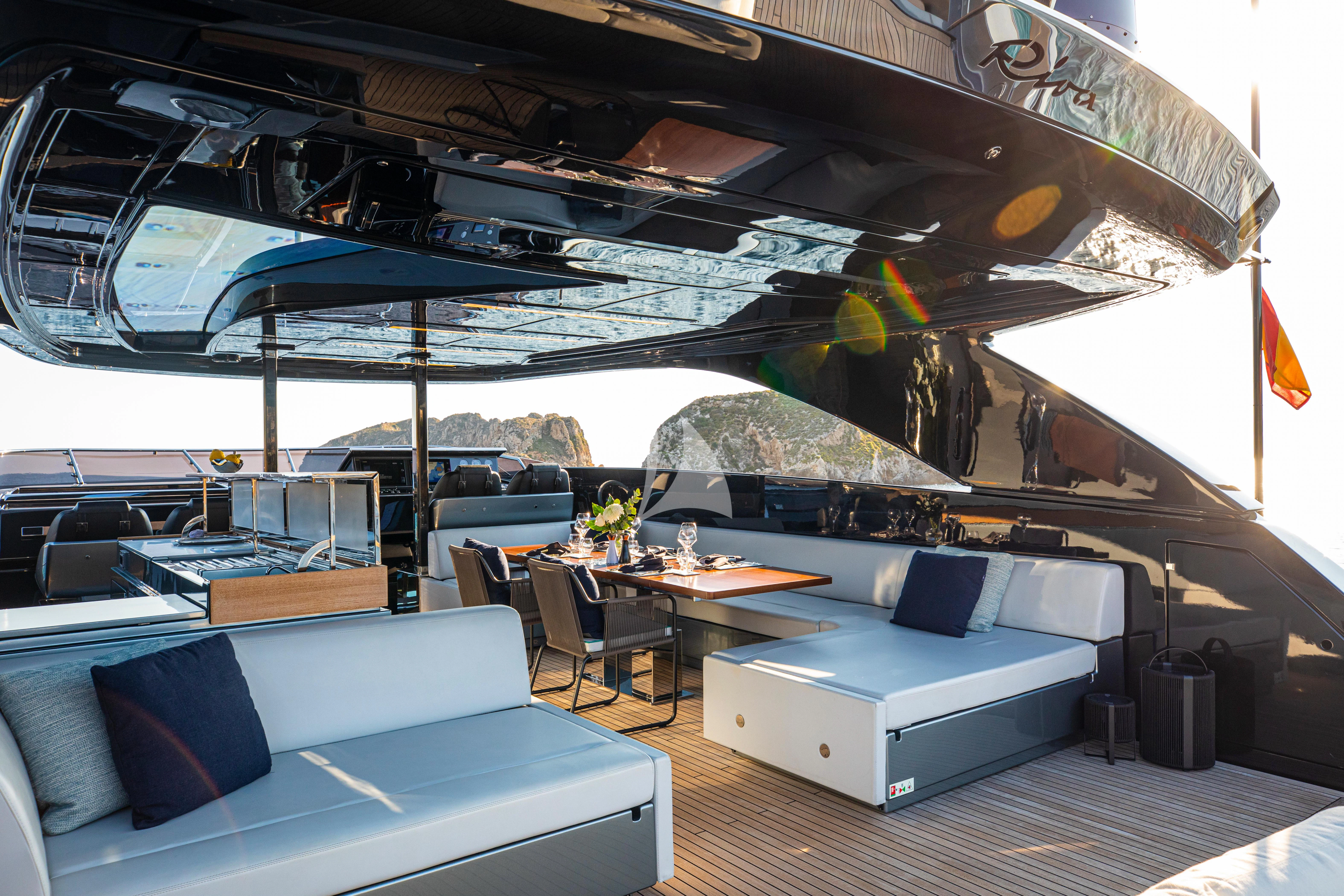 a room with a large bed and a table with chairs aboard FIGURATI Yacht for Sale