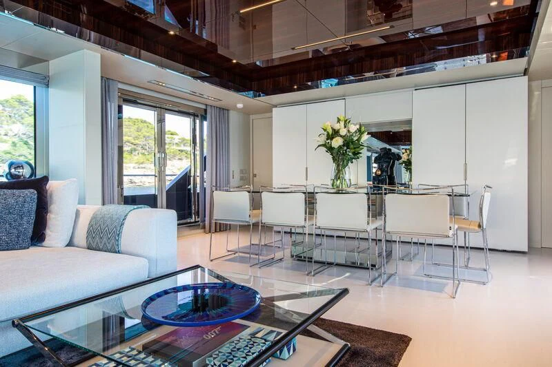 a living room with a table and chairs aboard FIGURATI Yacht for Sale