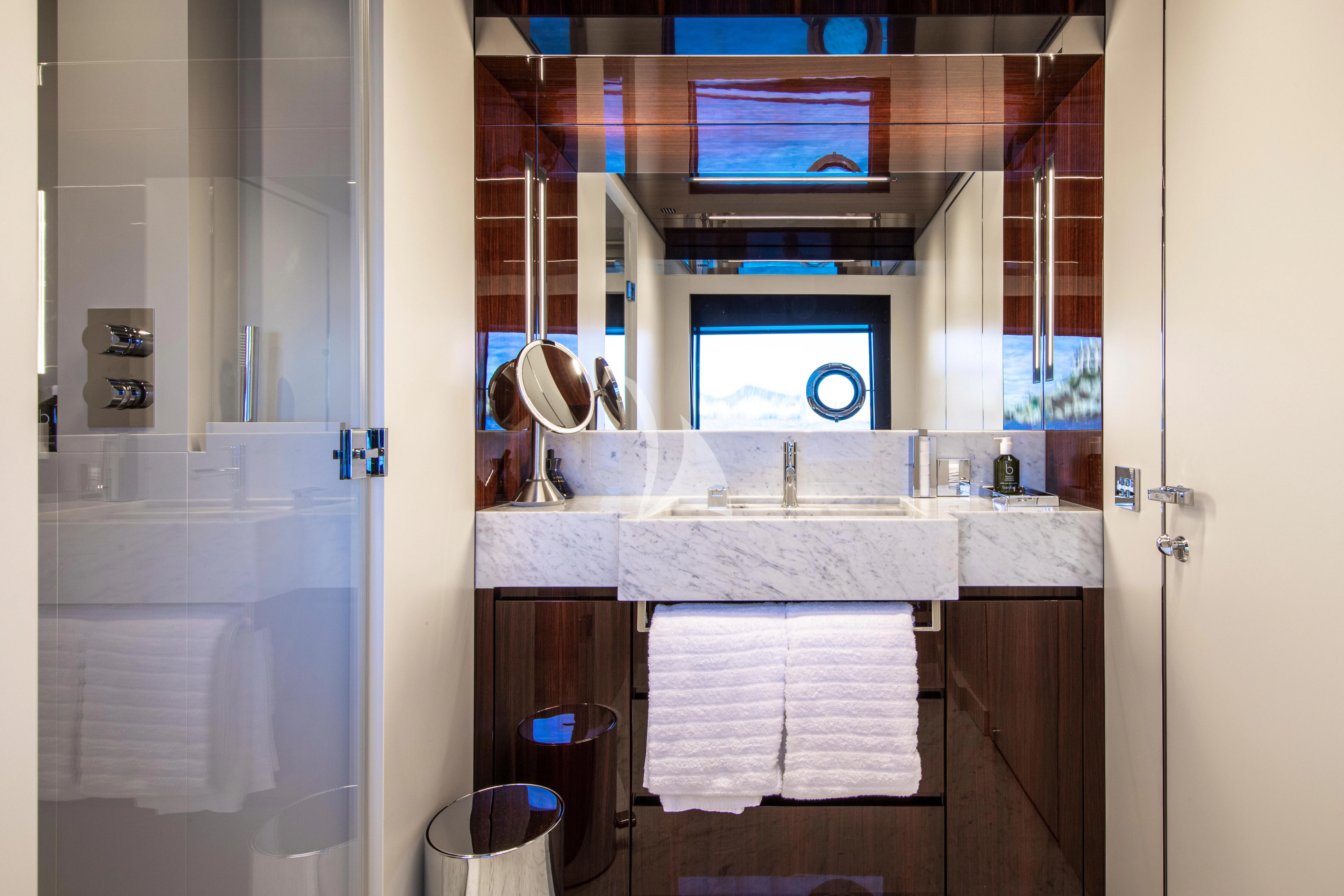a bathroom with a sink and a mirror aboard FIGURATI Yacht for Sale