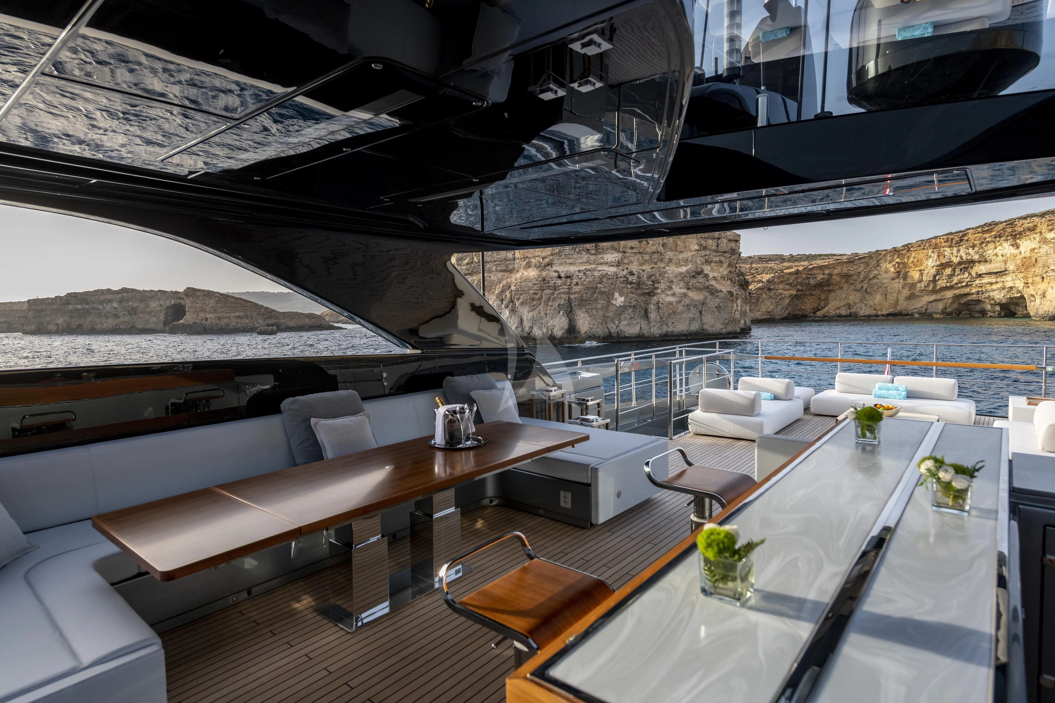 a room with a table and chairs aboard FIGURATI Yacht for Sale