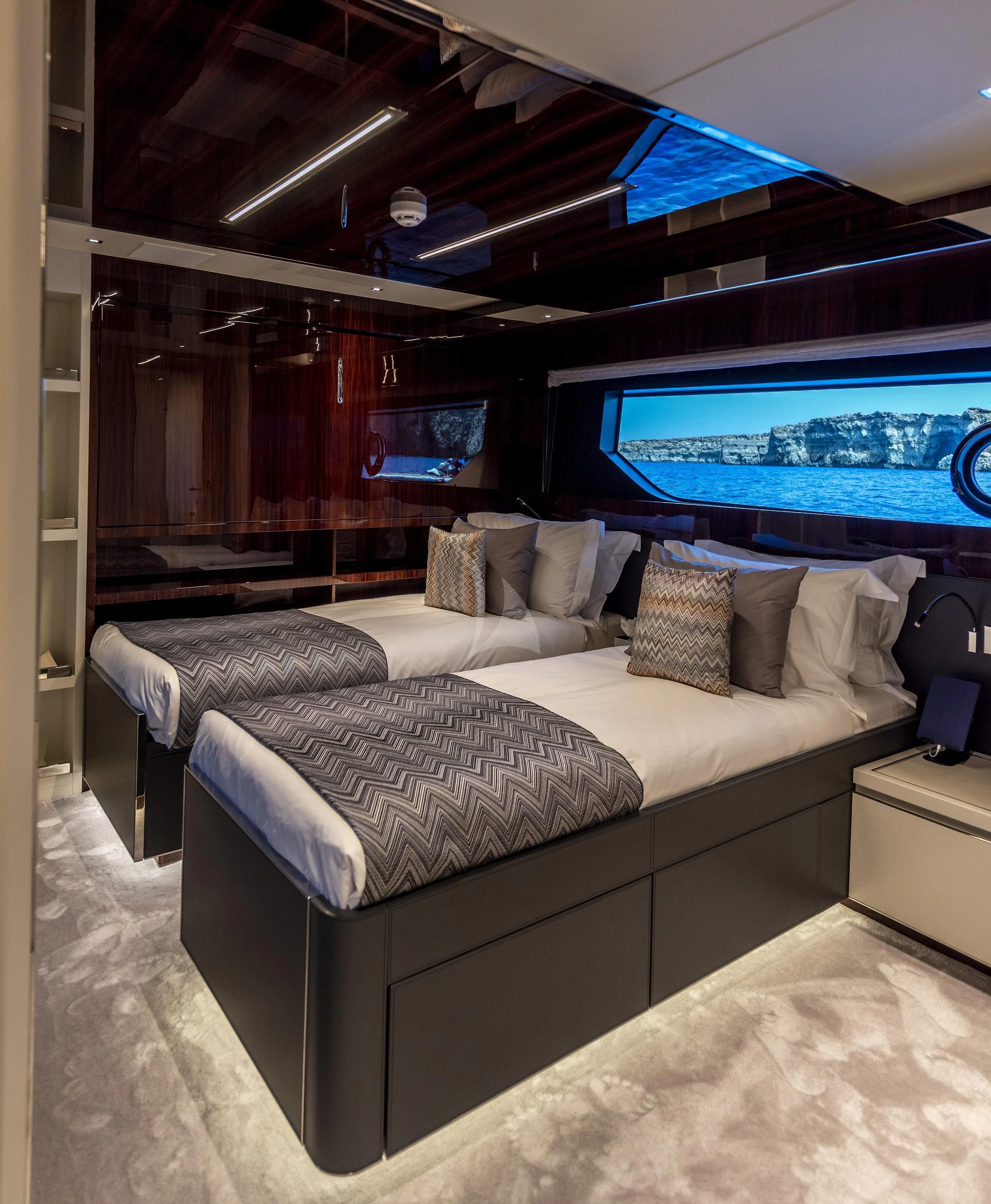 a bed with a tv on the wall aboard FIGURATI Yacht for Sale