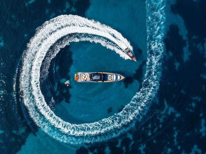a white and black car with Great Blue Hole in the background aboard FIGURATI Yacht for Sale