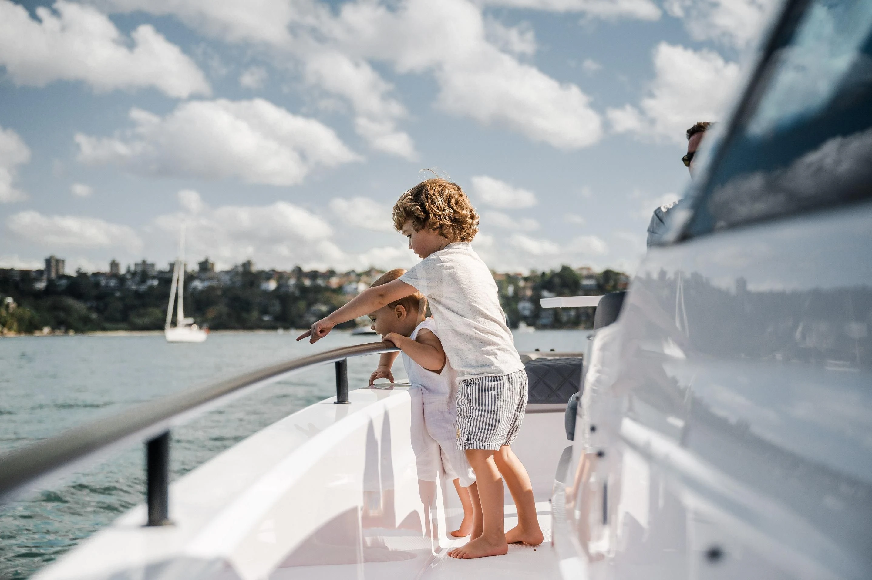 a man holding a baby on a boat aboard FIGURATI Yacht for Sale