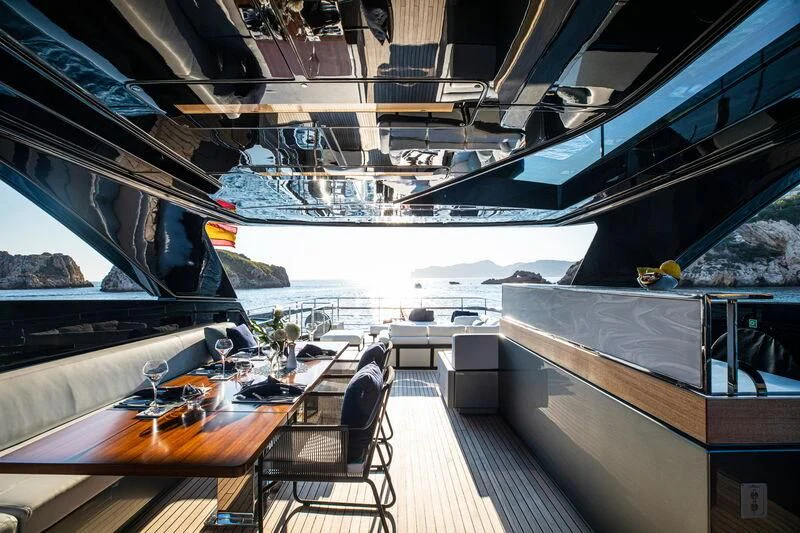 a room with a table and chairs aboard FIGURATI Yacht for Sale