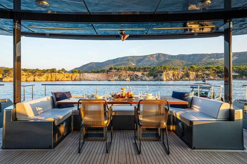 a table and chairs on a deck aboard FIGURATI Yacht for Sale