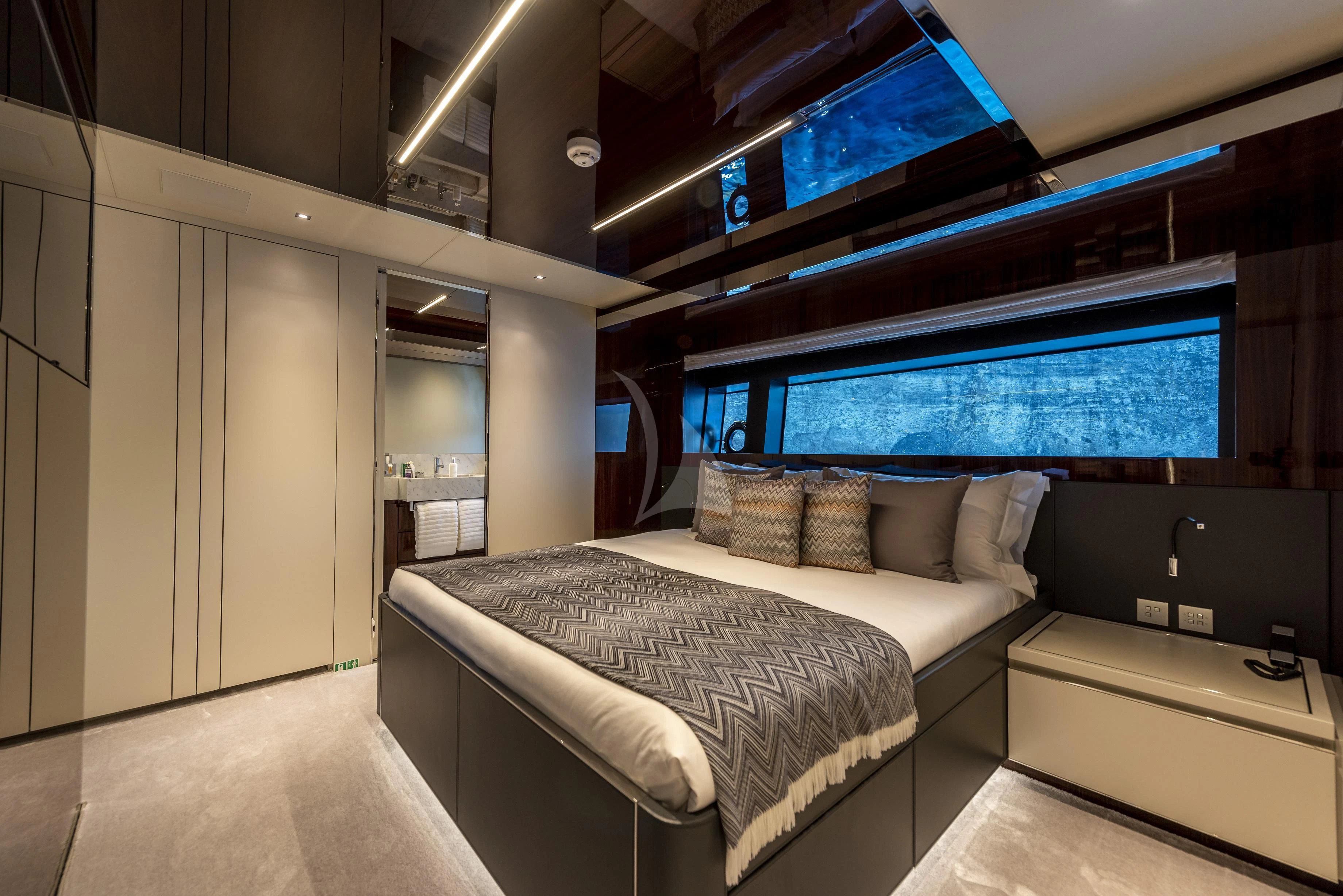 a room with a bed and a tv aboard FIGURATI Yacht for Sale