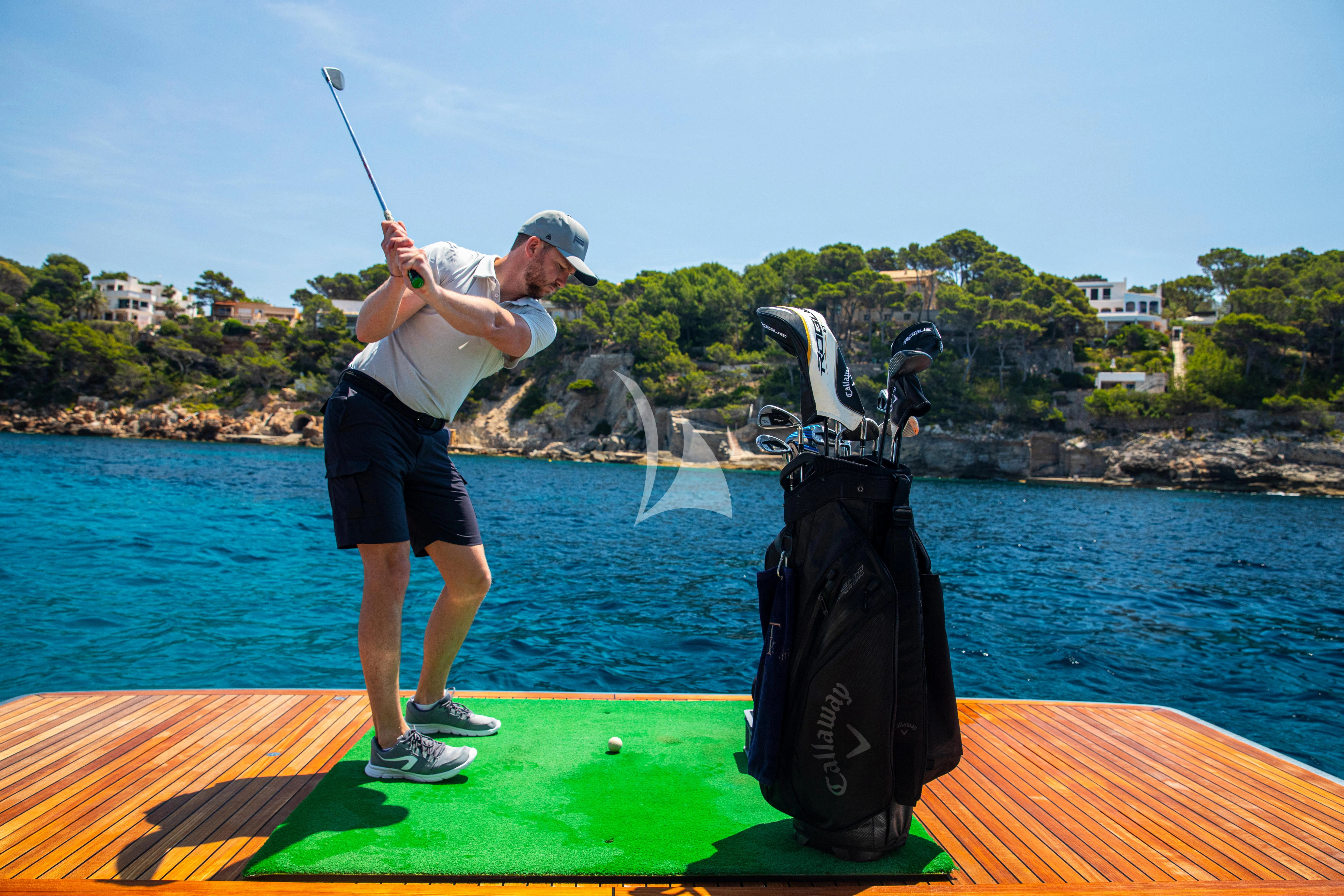 a person swinging a golf club aboard FIGURATI Yacht for Sale
