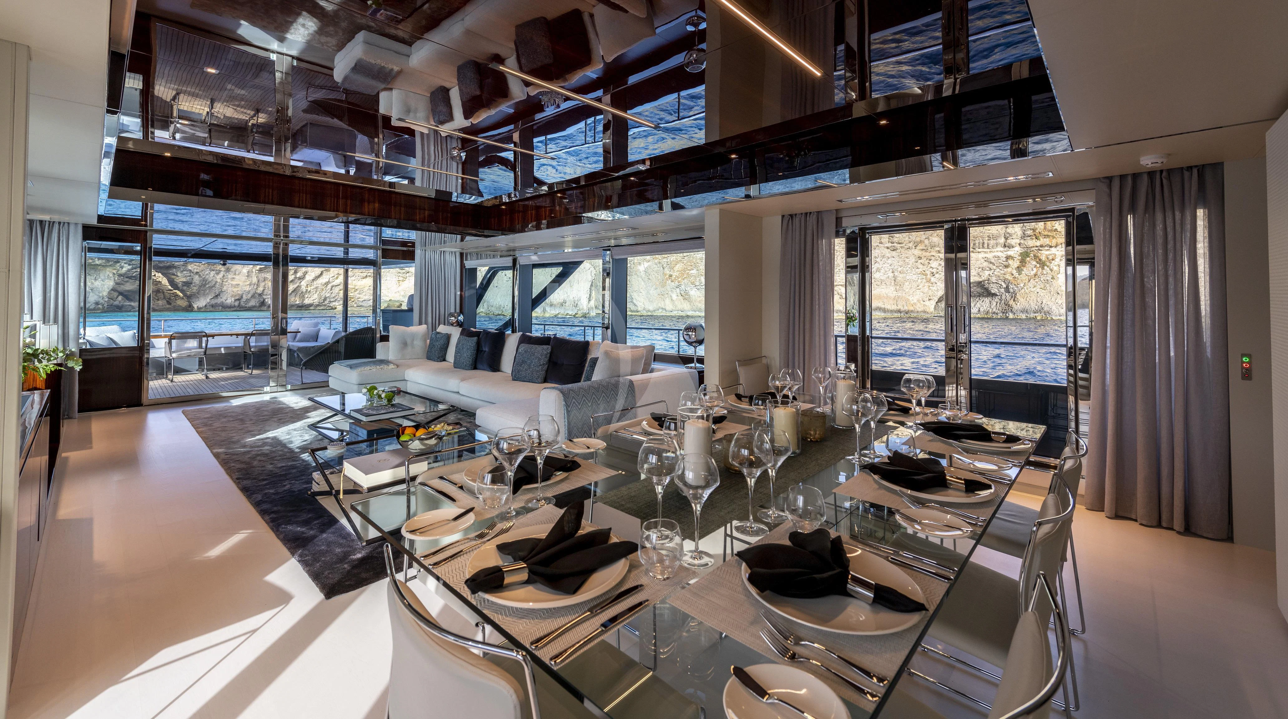 a room with tables and chairs aboard FIGURATI Yacht for Sale