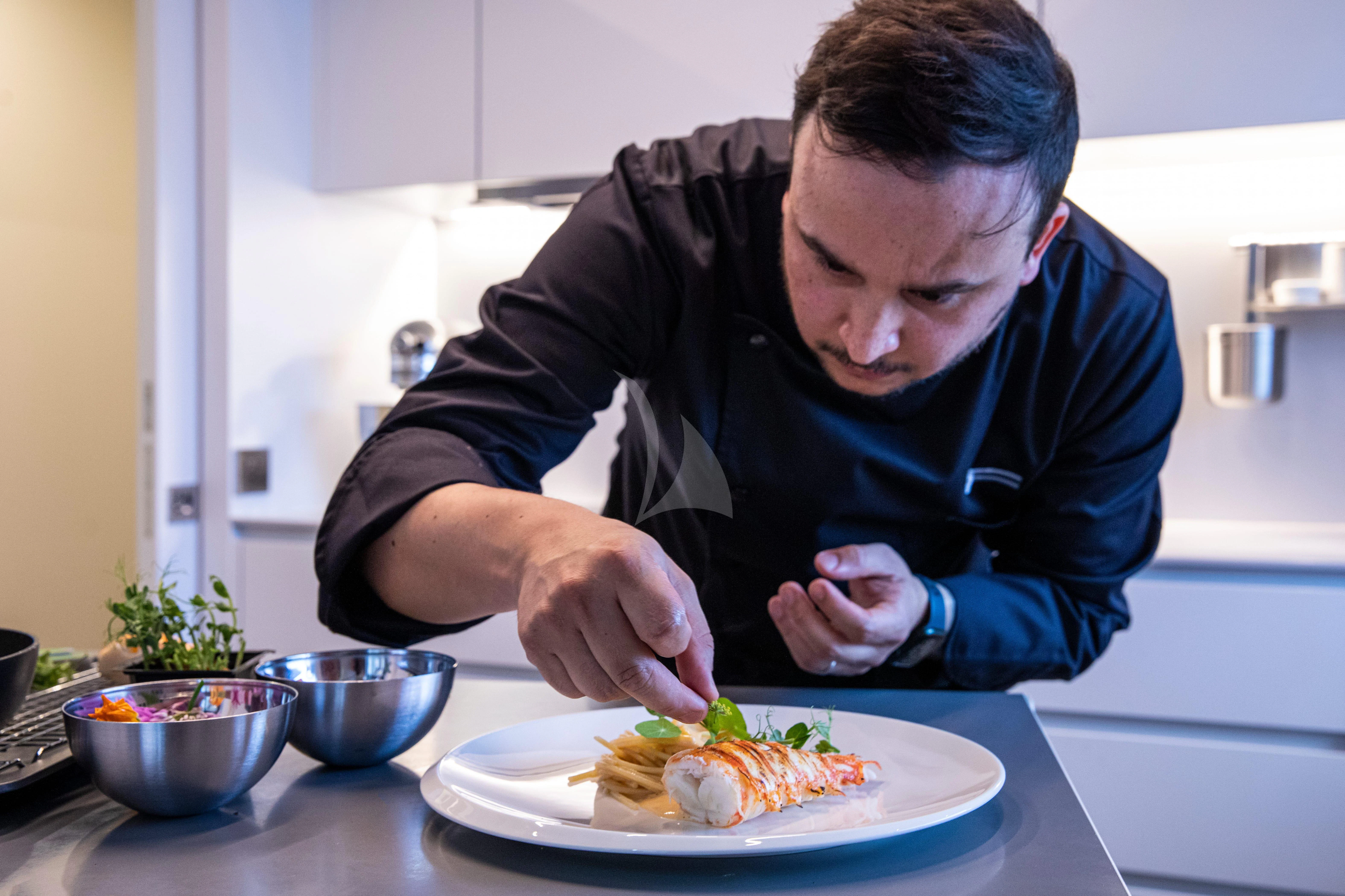 a man eating a plate of food aboard FIGURATI Yacht for Sale