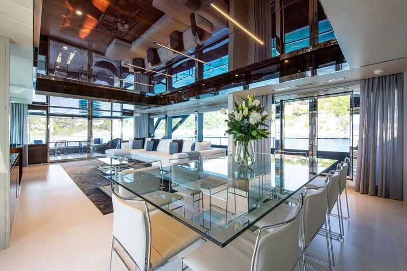 a large room with a table and chairs aboard FIGURATI Yacht for Sale