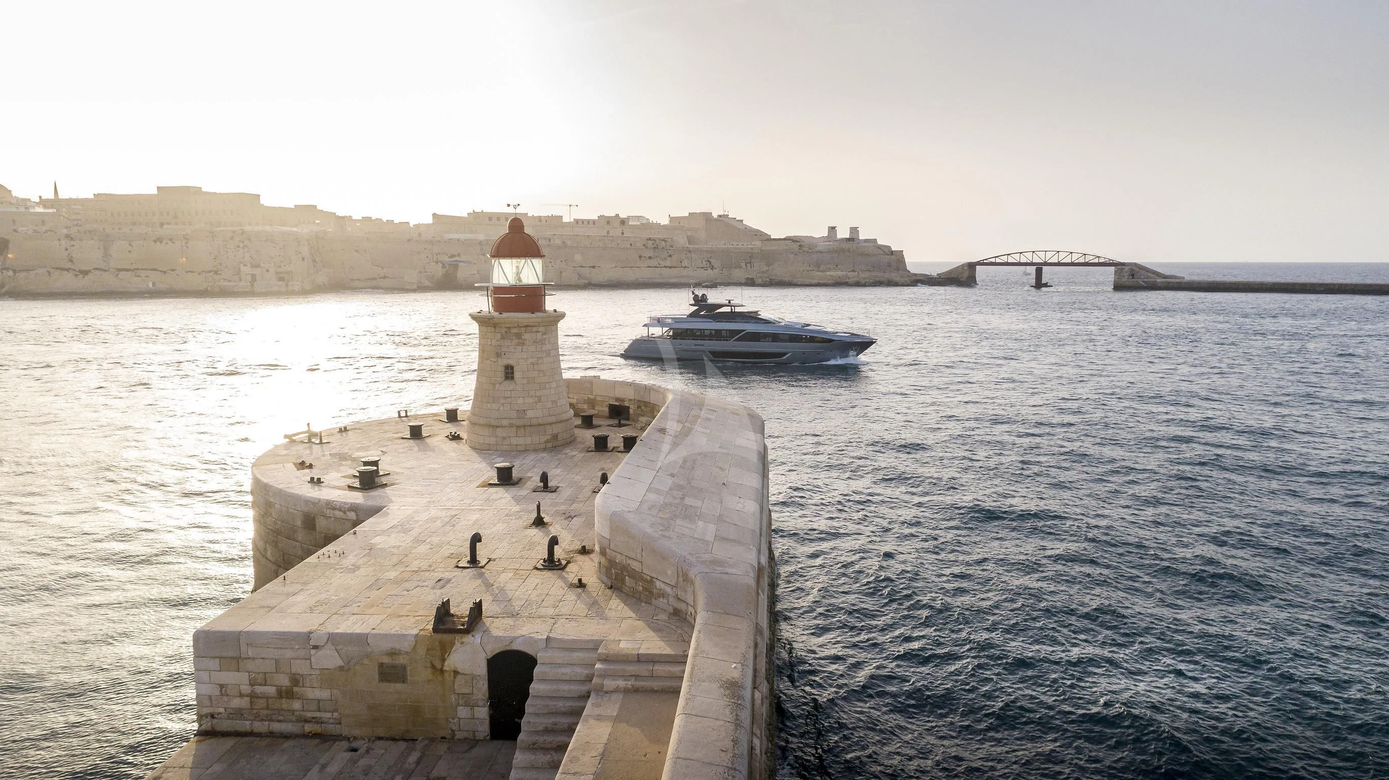 a dock leading to a lighthouse aboard FIGURATI Yacht for Sale