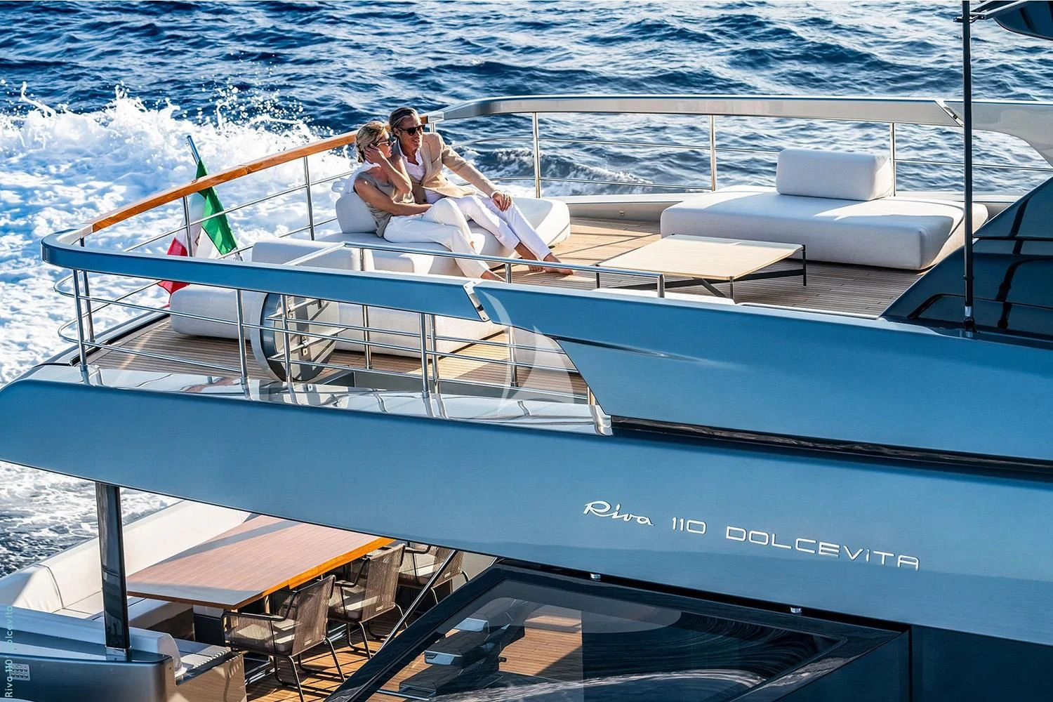 a couple sitting on a boat aboard FIGURATI Yacht for Sale