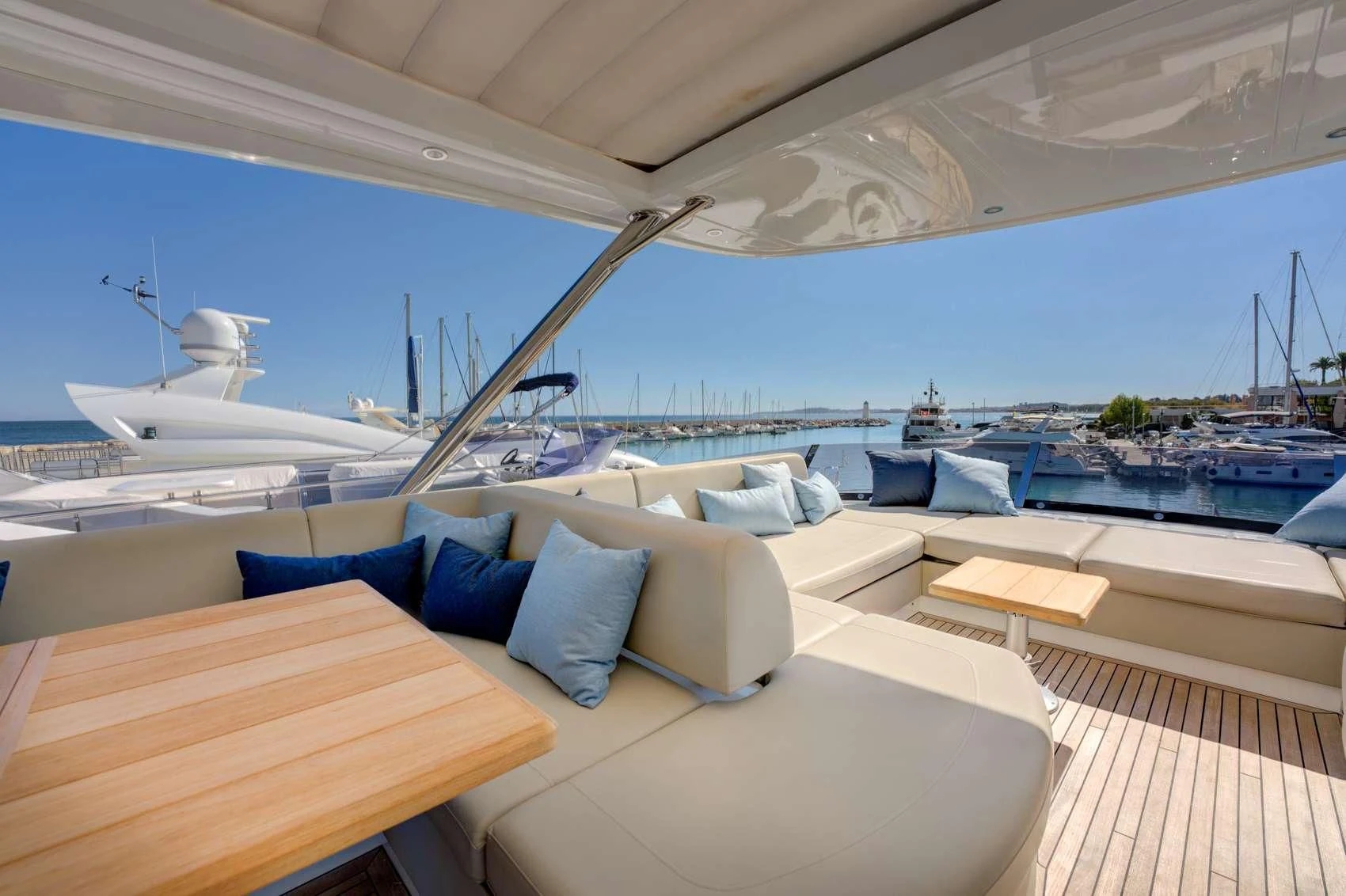 a large lounge area with a large ship in the background aboard MIKEL ANGELO Yacht for Charter