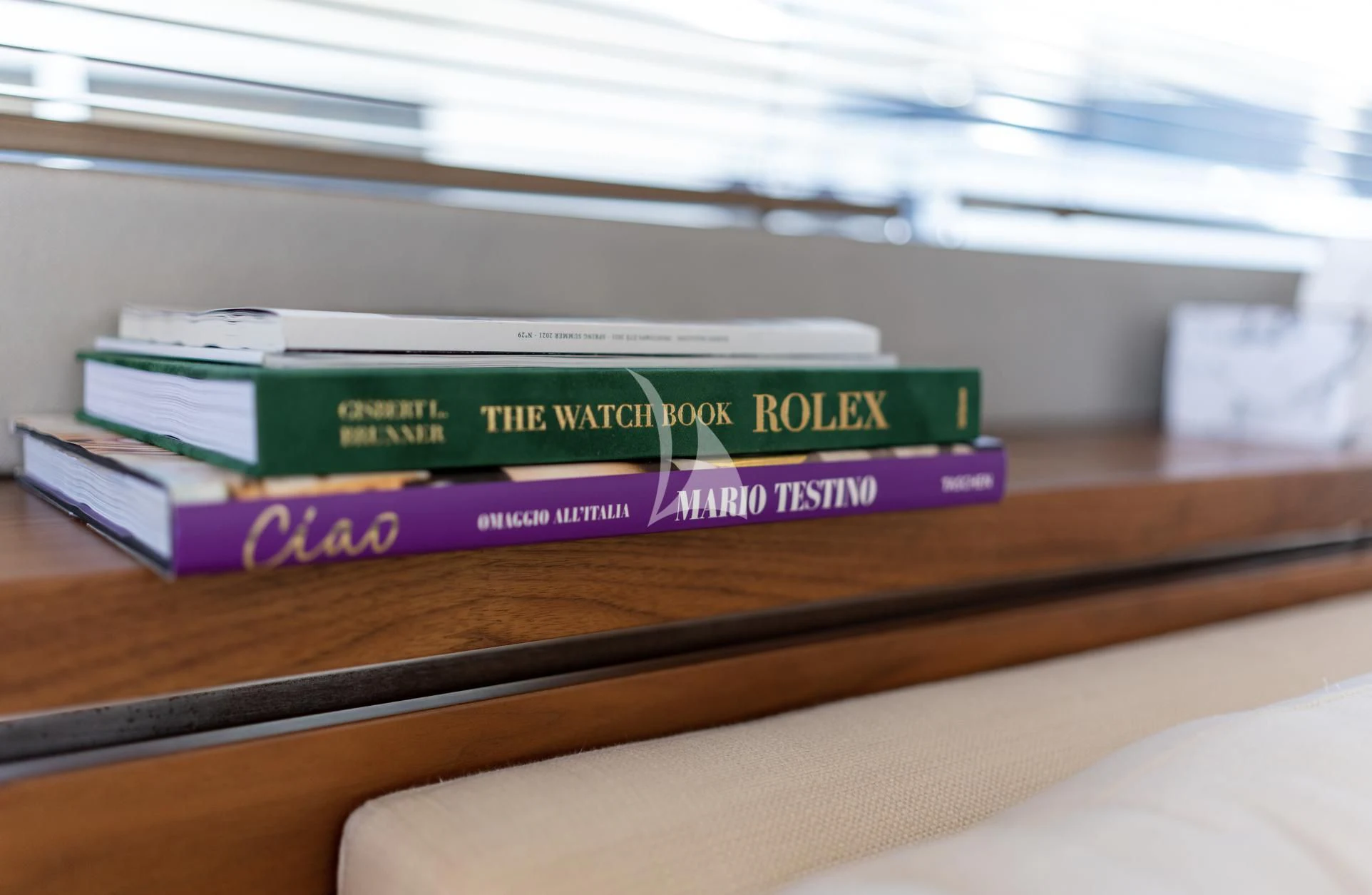 a stack of books on a desk aboard MIKEL ANGELO Yacht for Charter