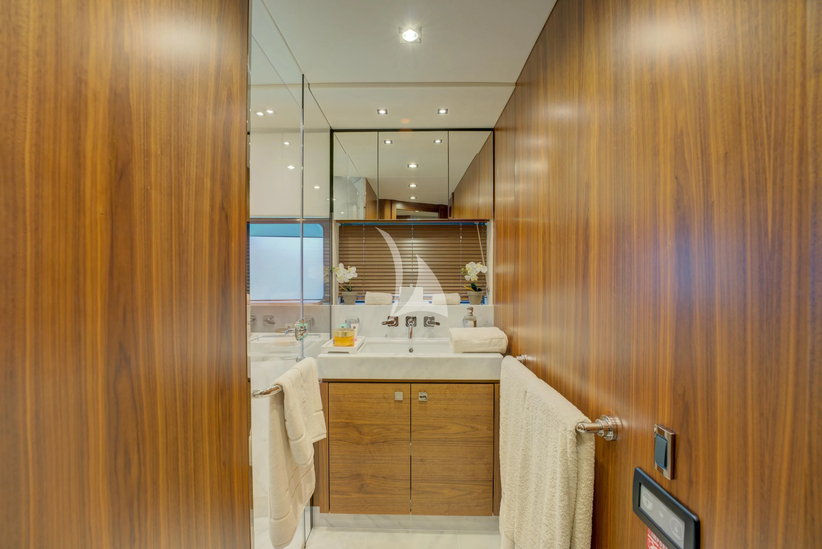 a bathroom with wooden cabinets aboard MIKEL ANGELO Yacht for Charter