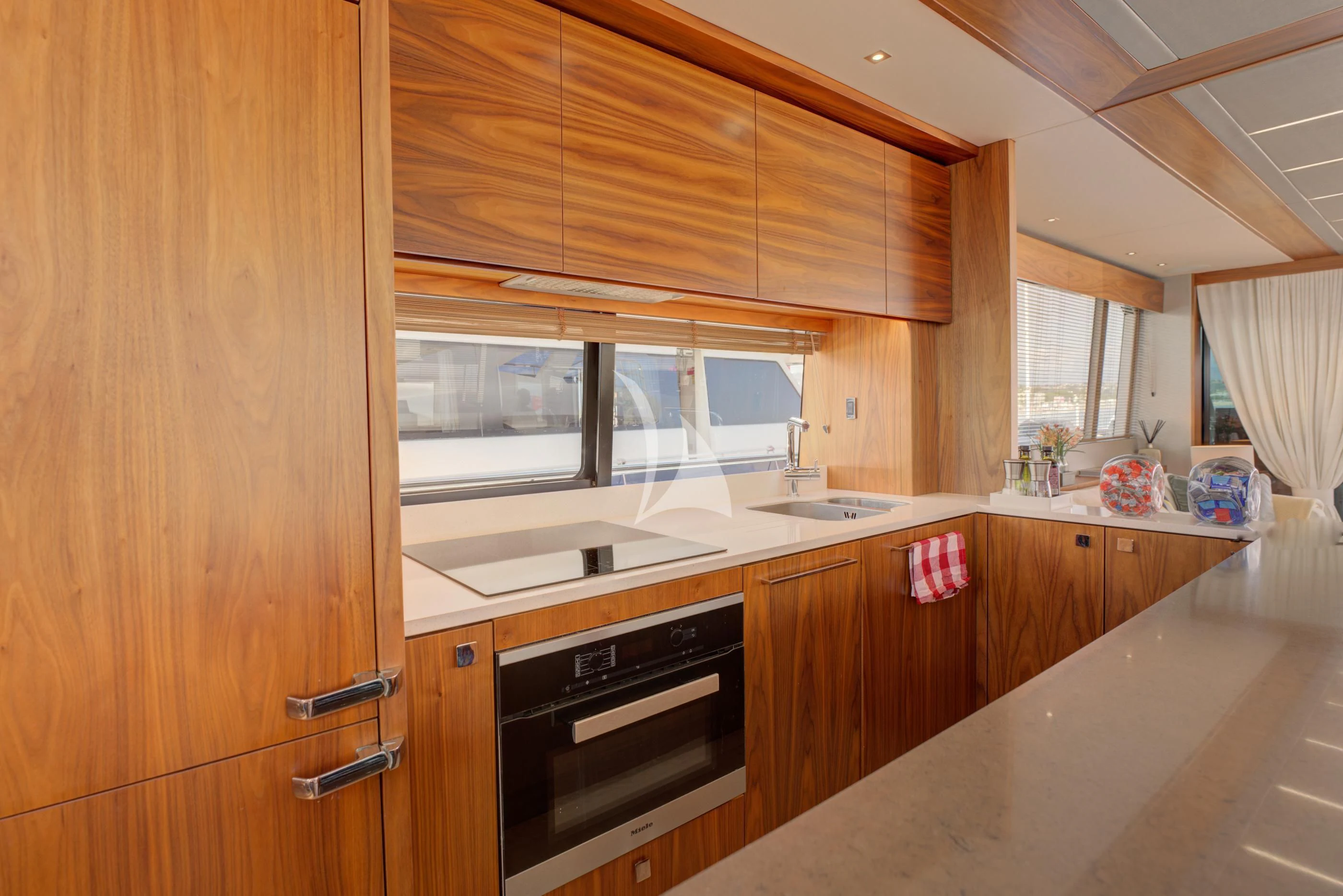 a kitchen with wooden cabinets aboard MIKEL ANGELO Yacht for Charter