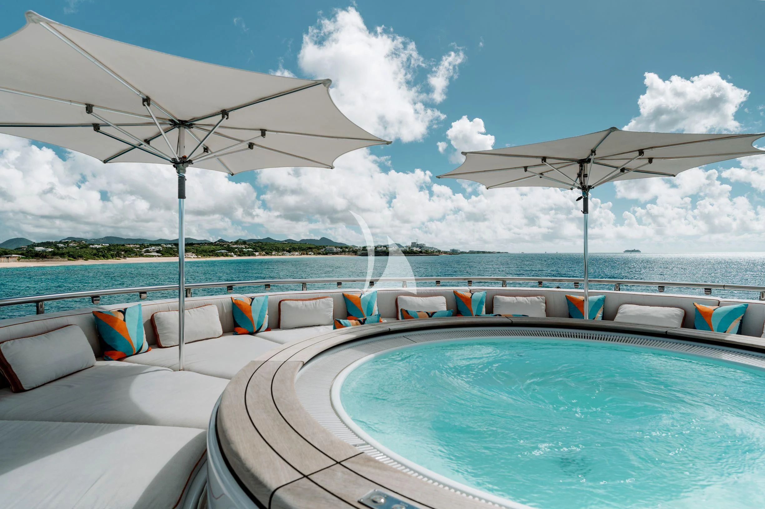 a swimming pool with chairs and umbrellas on a sunny day aboard BELLA Yacht for Sale