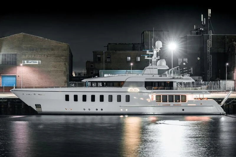 a large white boat in a harbor aboard BELLA Yacht for Sale