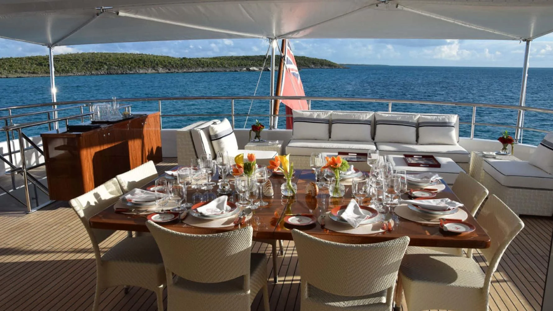 a table set for a dinner on a boat aboard BELLA Yacht for Sale