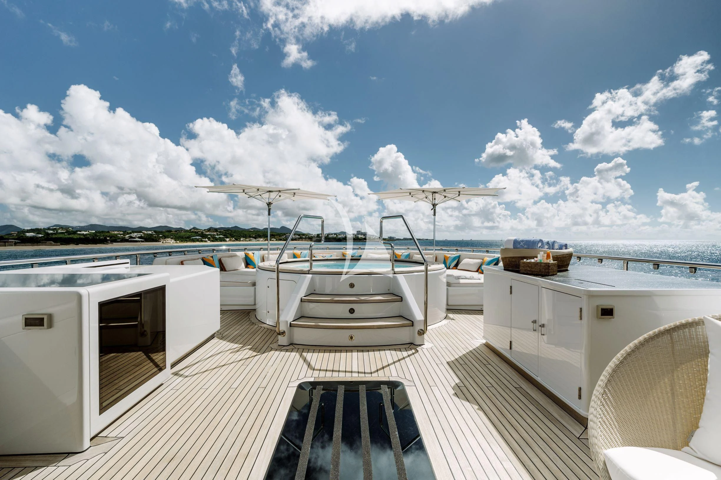 a deck with a boat and a deck with chairs on it aboard BELLA Yacht for Sale
