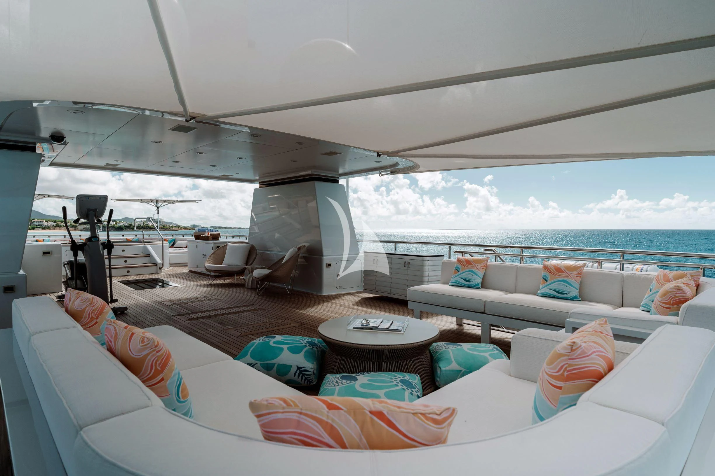 a room with a couch and a table with pillows on it aboard BELLA Yacht for Sale