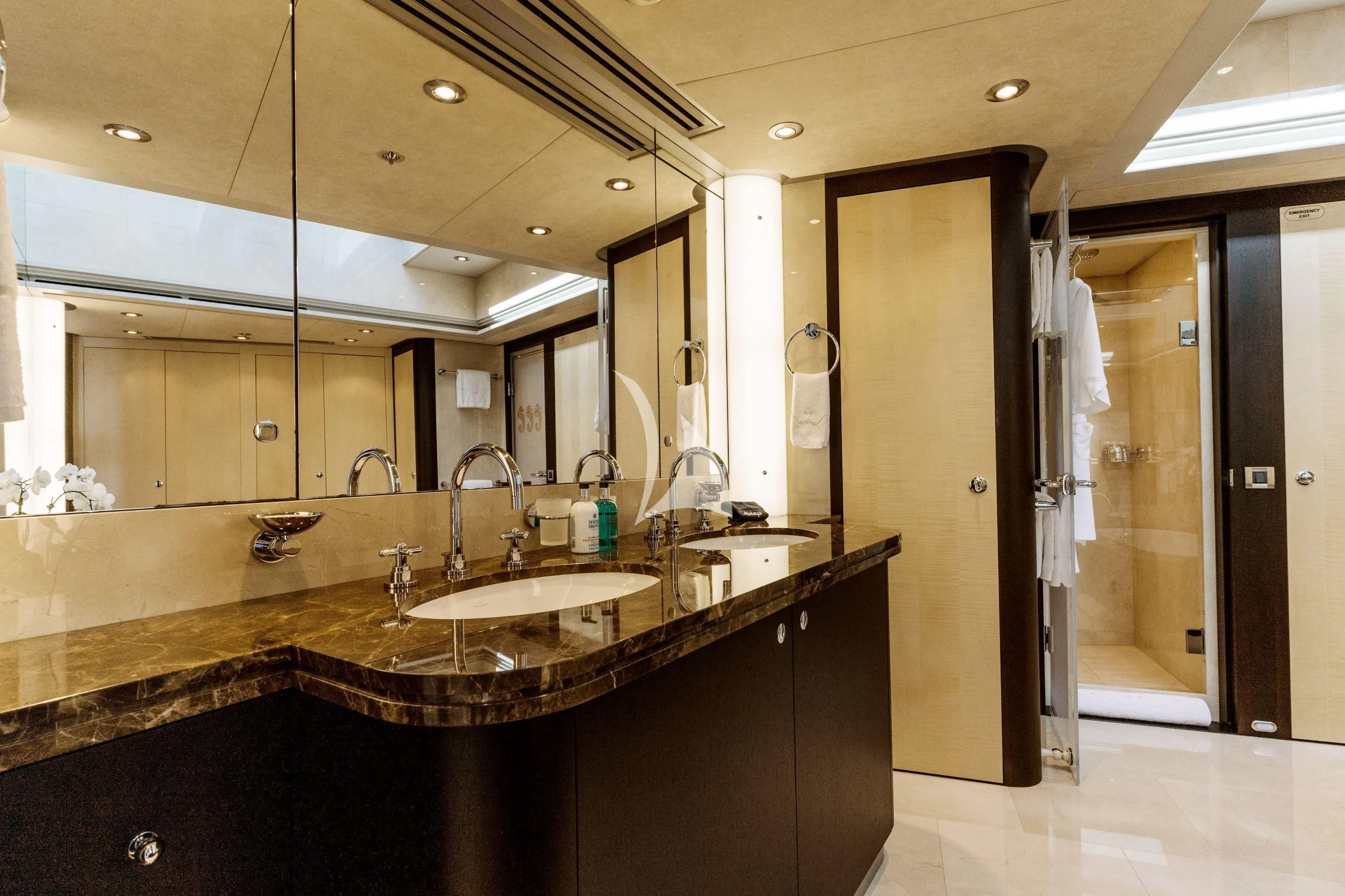 a bathroom with a countertop sink and mirrors aboard BELLA Yacht for Sale