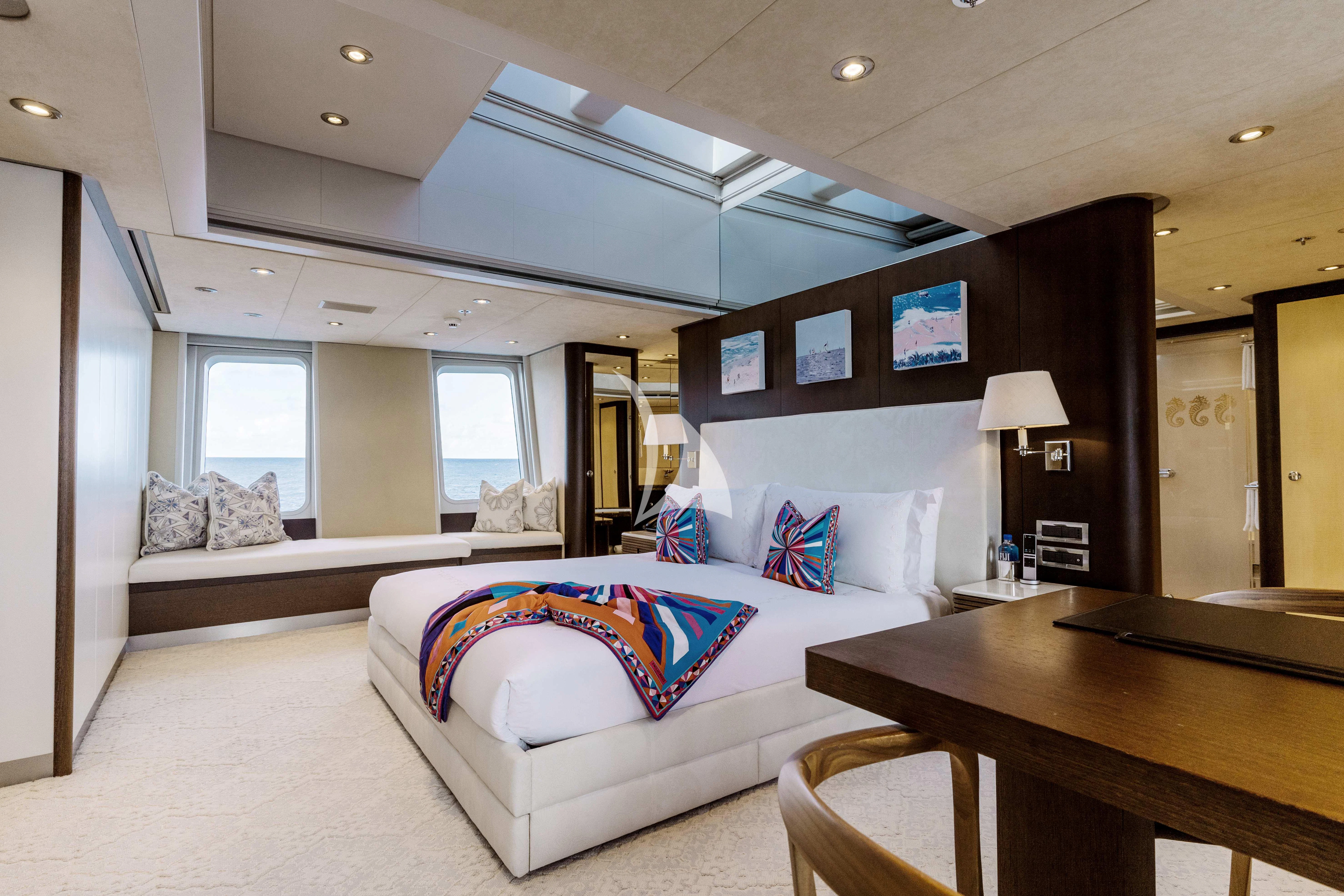 a bedroom with a bed and a desk aboard BELLA Yacht for Sale