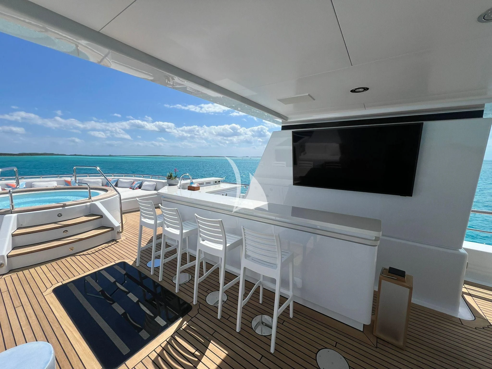 a room with a balcony and a view of the ocean aboard BELLA Yacht for Sale
