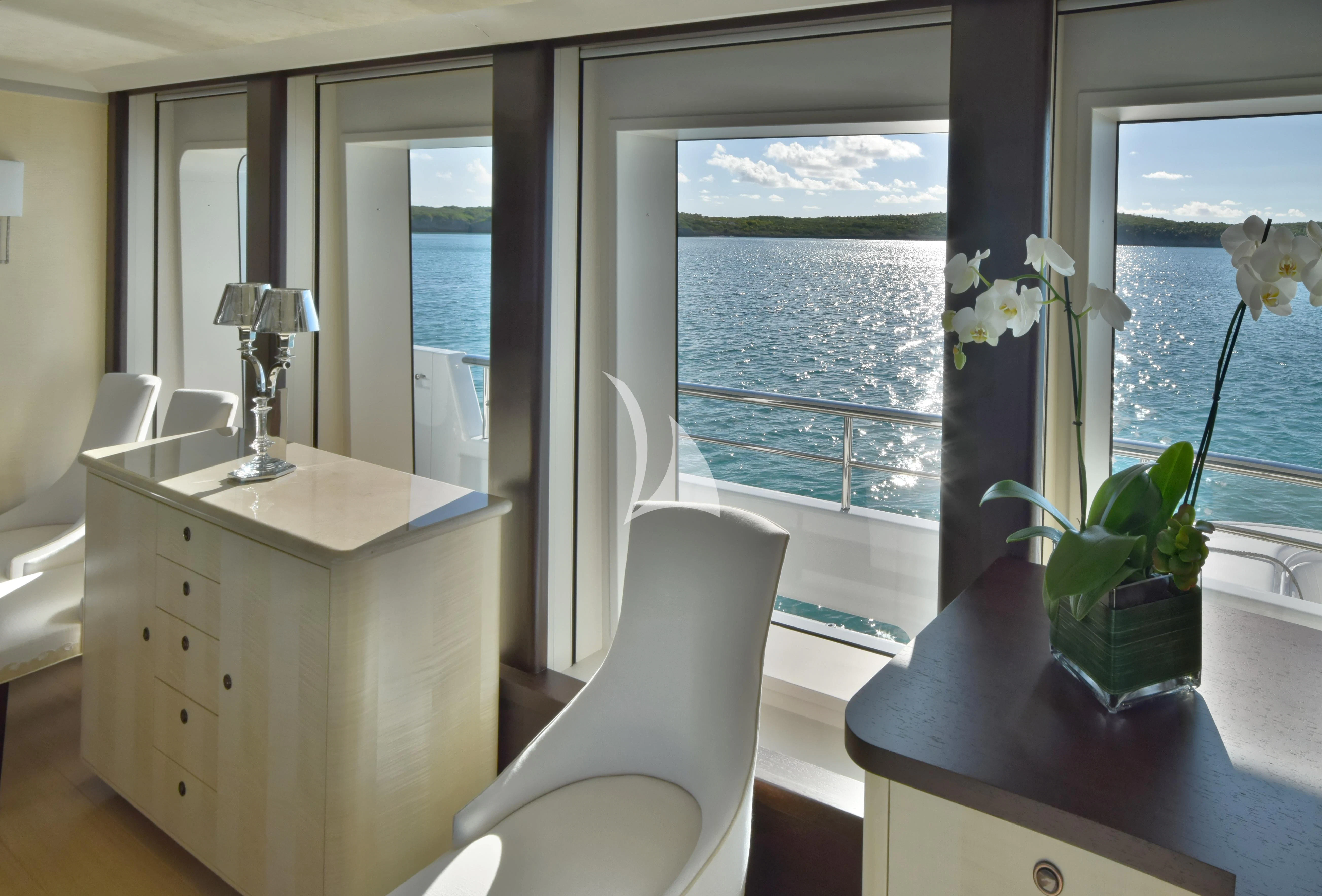 a room with a desk and a window with a plant in it aboard BELLA Yacht for Sale