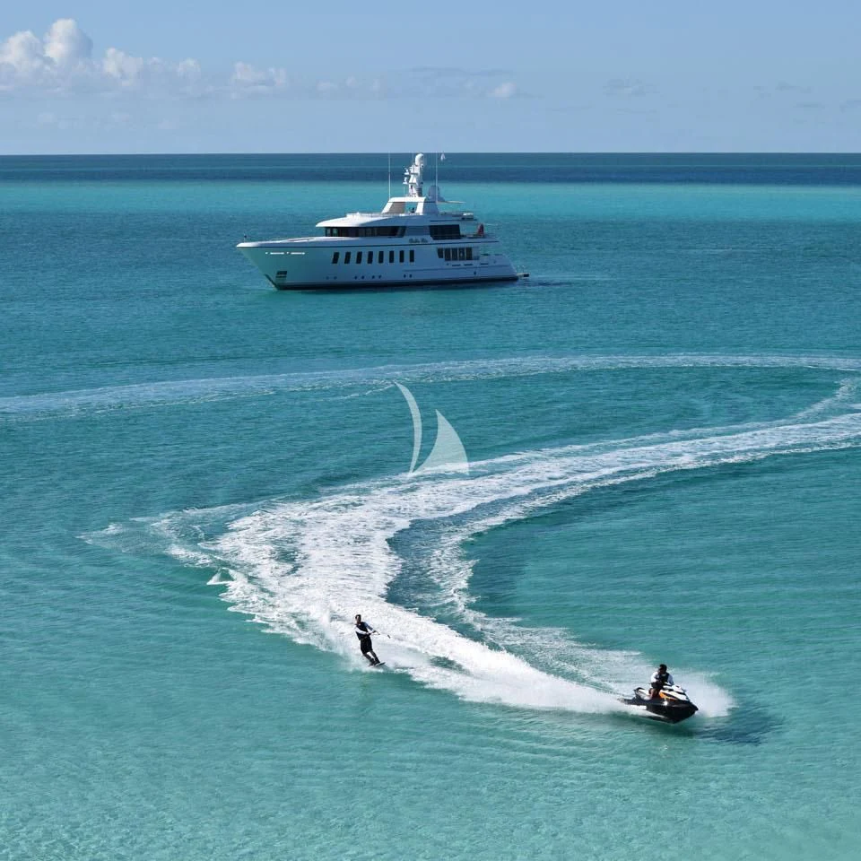 a boat and a couple people in the water aboard BELLA Yacht for Sale