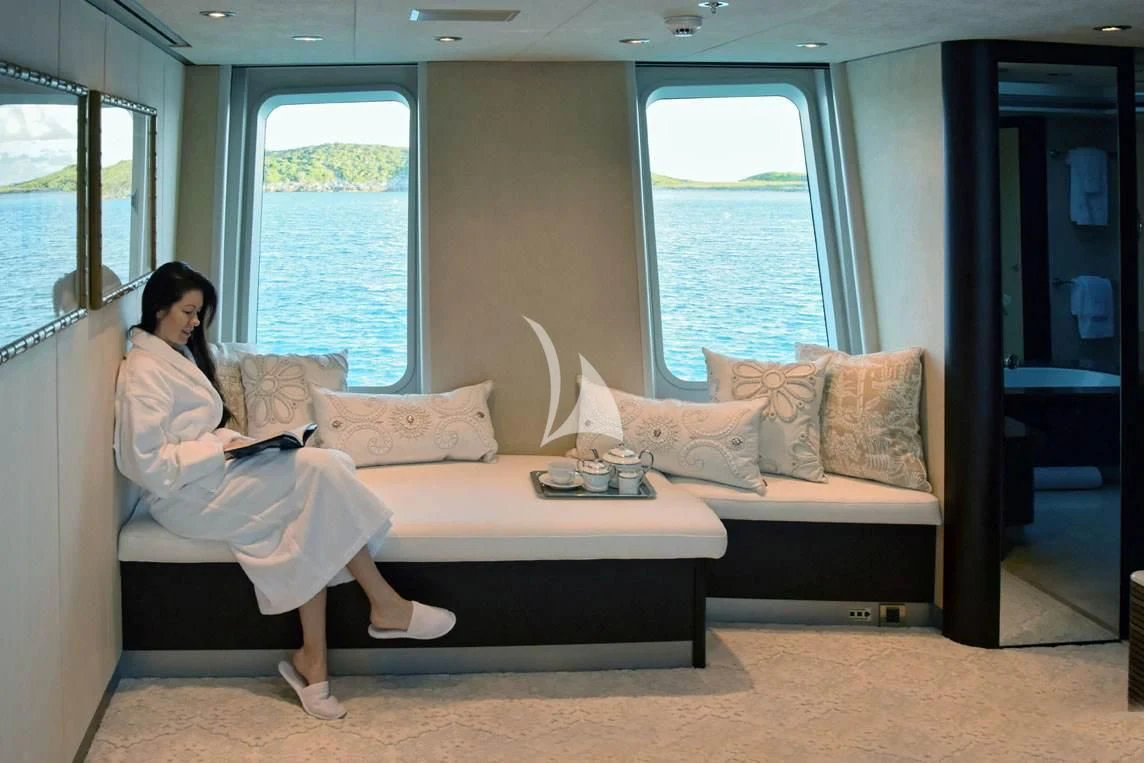 a person sitting on a couch aboard BELLA Yacht for Sale