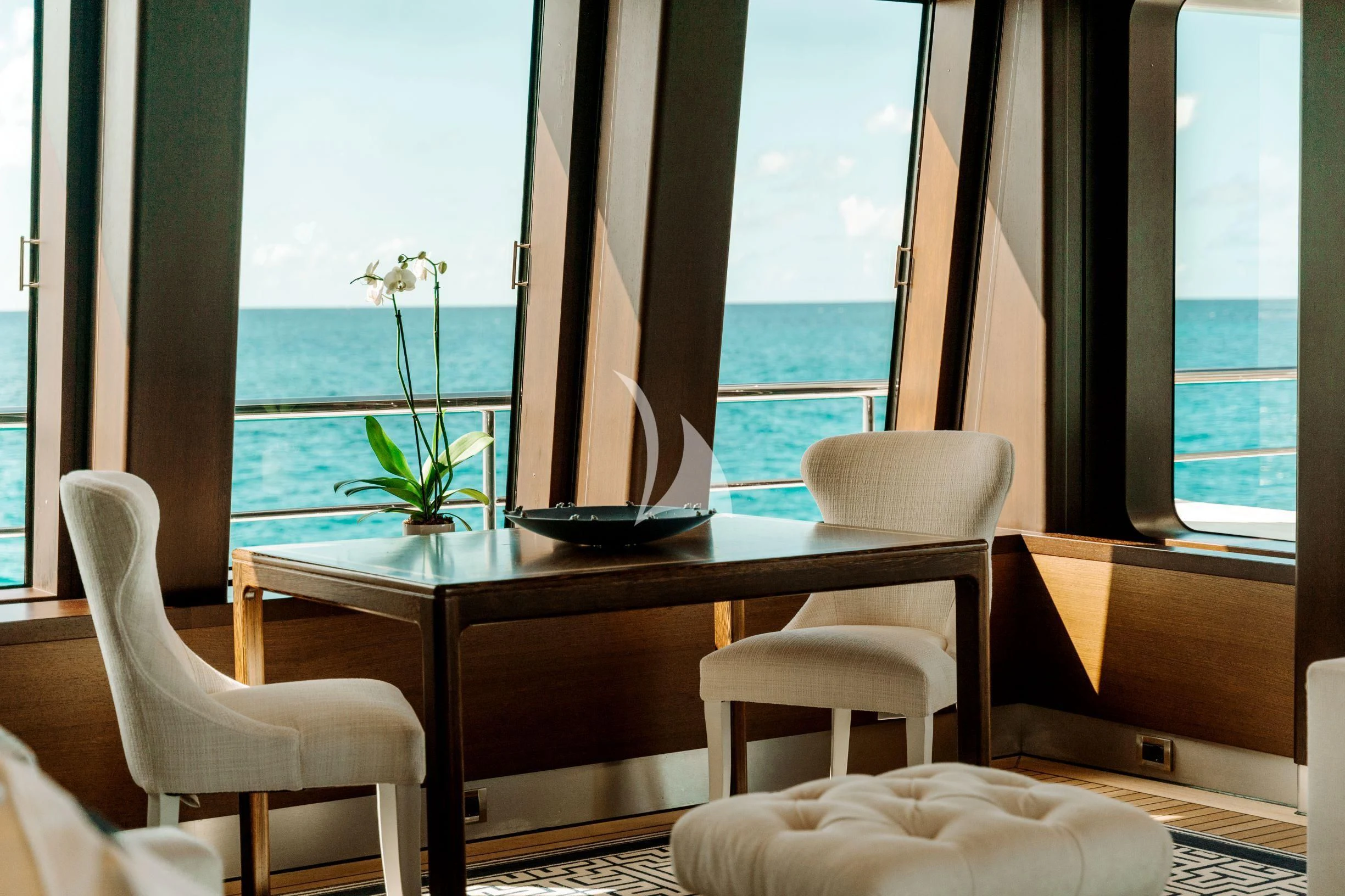 a table with chairs and a plant on it aboard BELLA Yacht for Sale