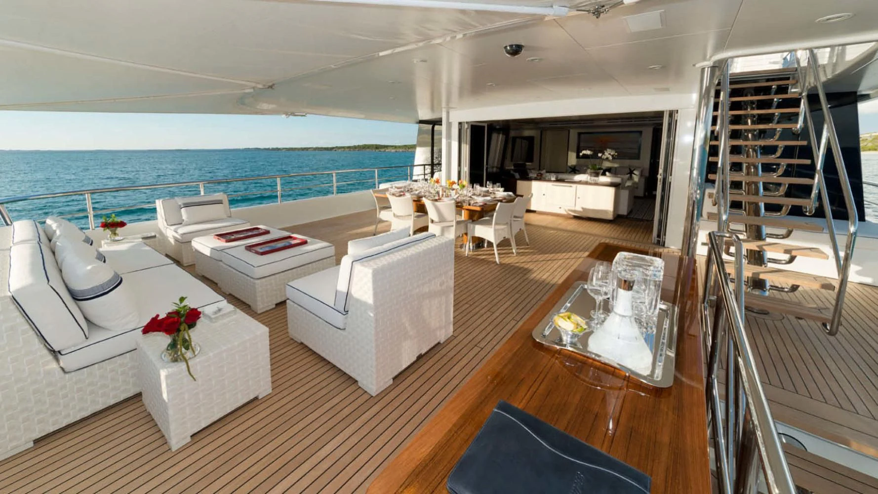 a living room with a large balcony aboard BELLA Yacht for Sale