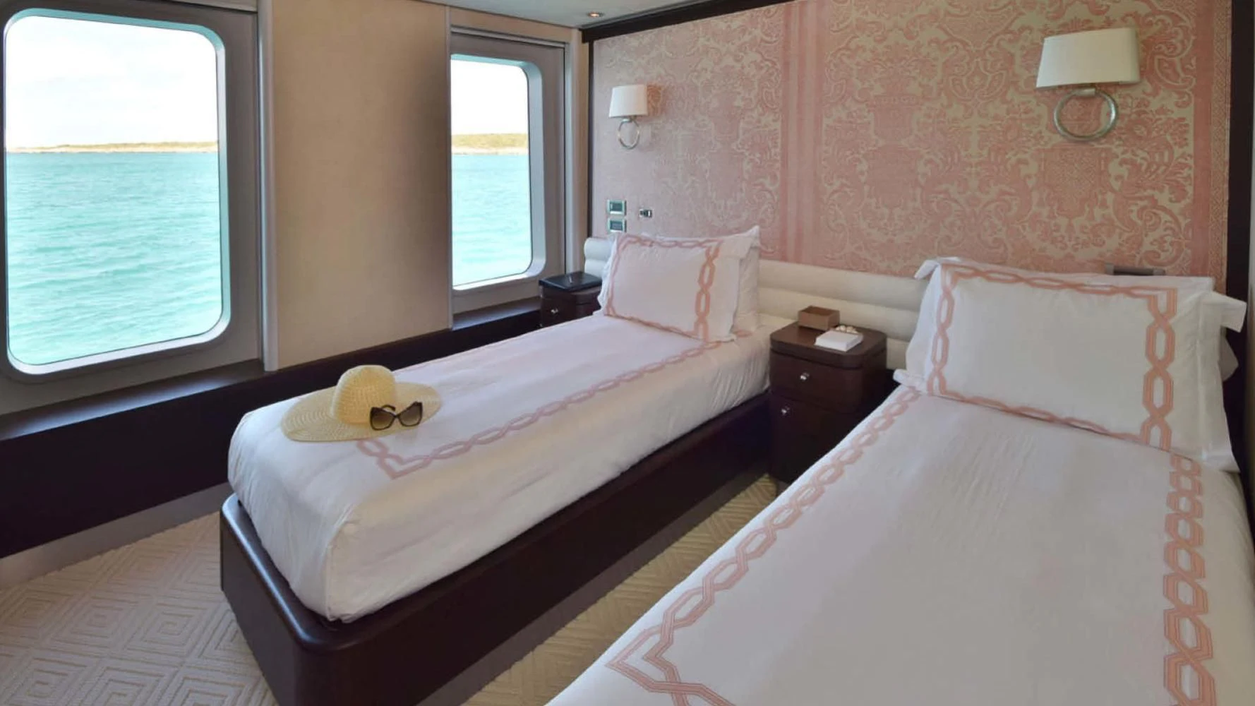 a couple of beds in a hotel room aboard BELLA Yacht for Sale