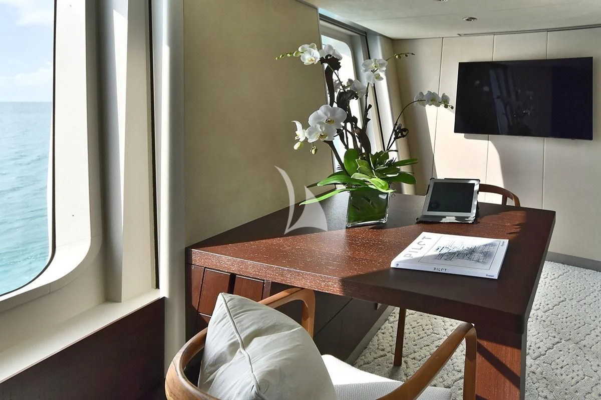 a table with a laptop on it aboard BELLA Yacht for Sale