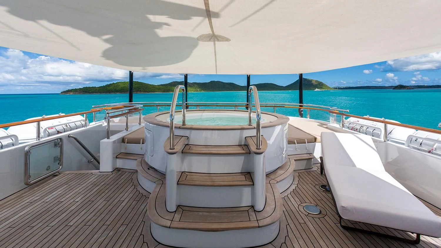 a deck with chairs on it by the water aboard MICHAELA ROSE Yacht for Sale