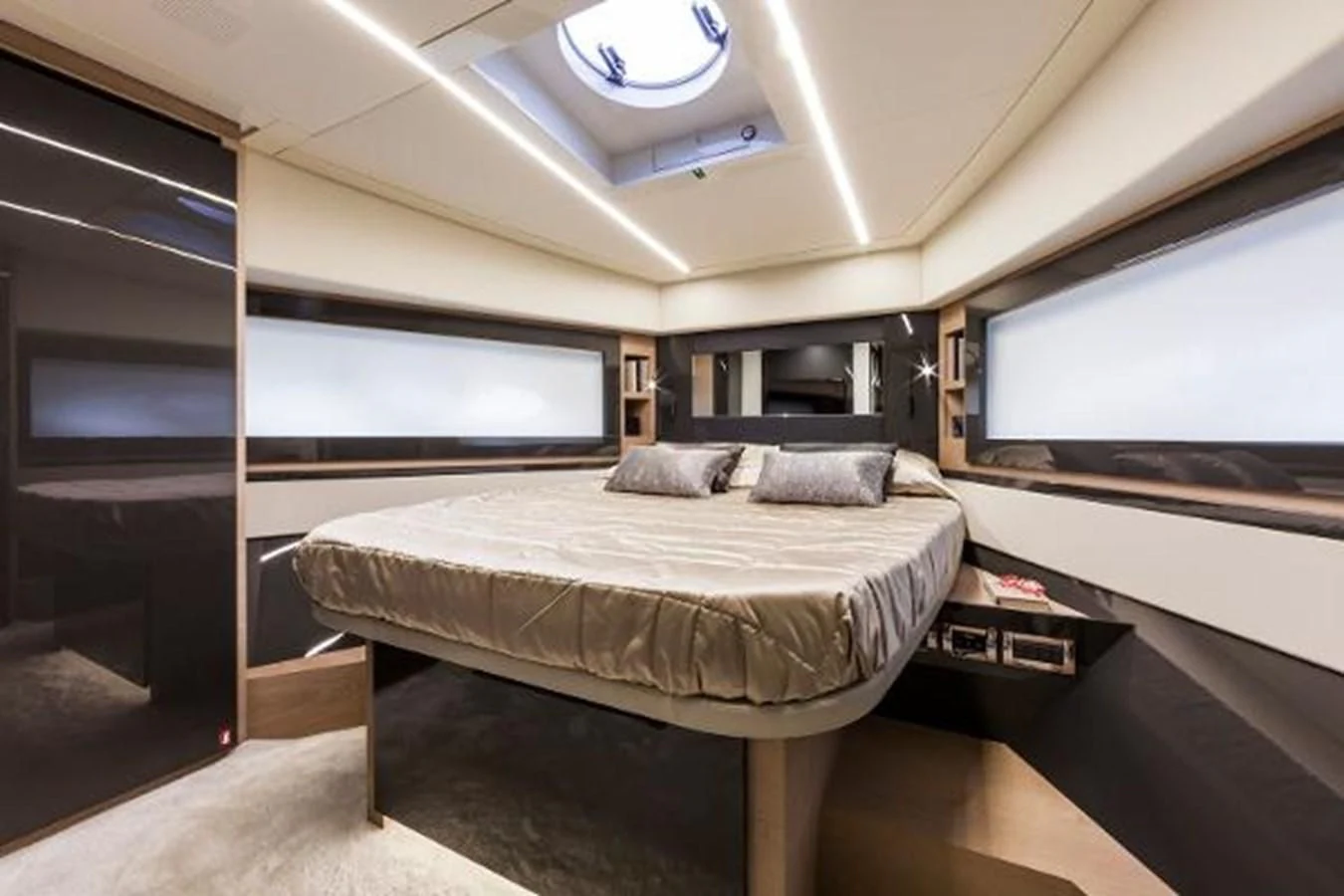a room with a bed and a large screen aboard STAR Yacht for Sale