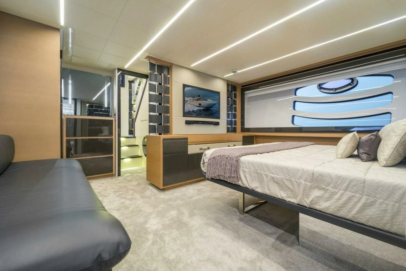 a bedroom with a bed and a couch aboard STAR Yacht for Sale