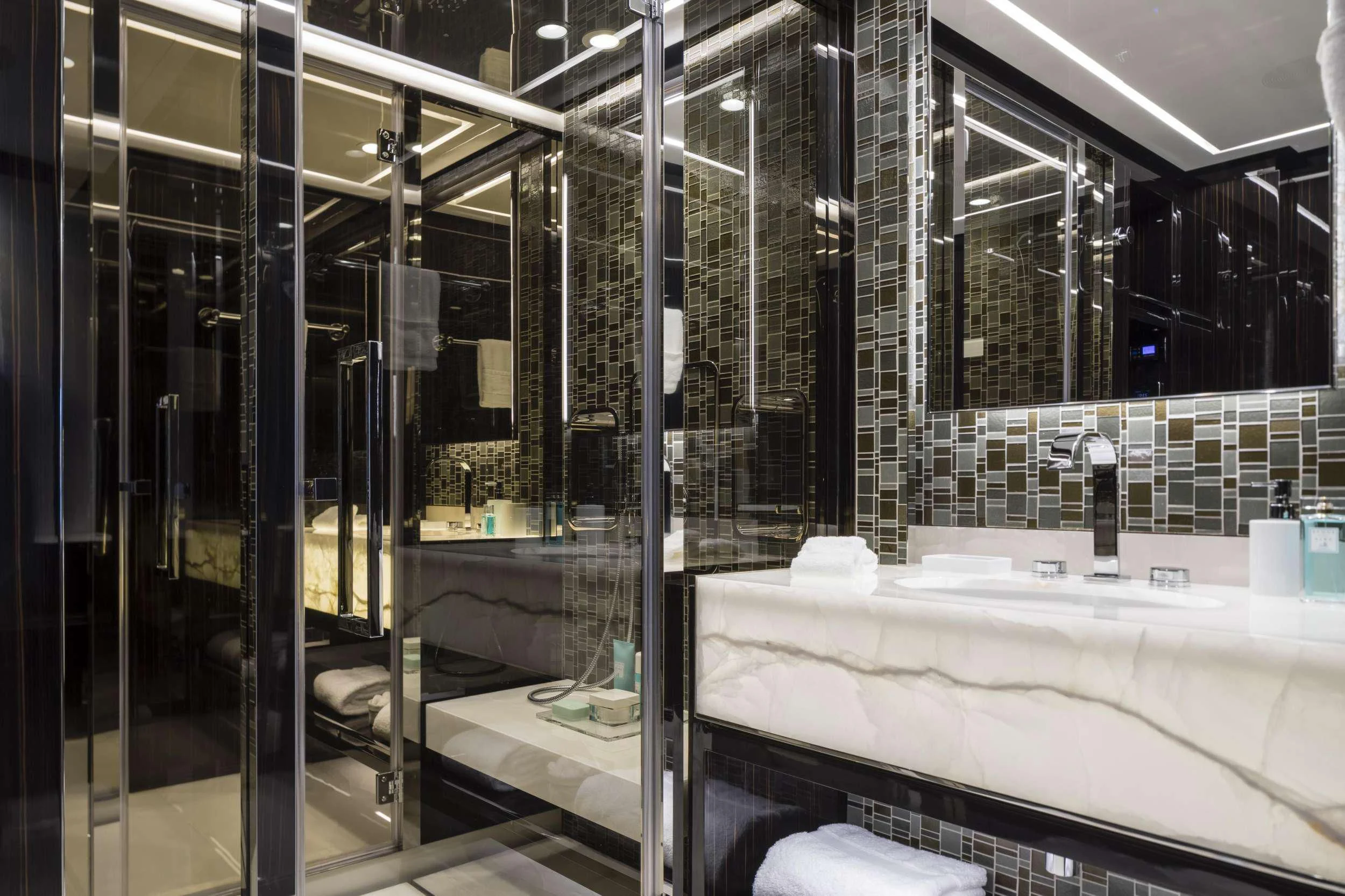 a bathroom with a large glass shower aboard ANDIAMO Yacht for Sale