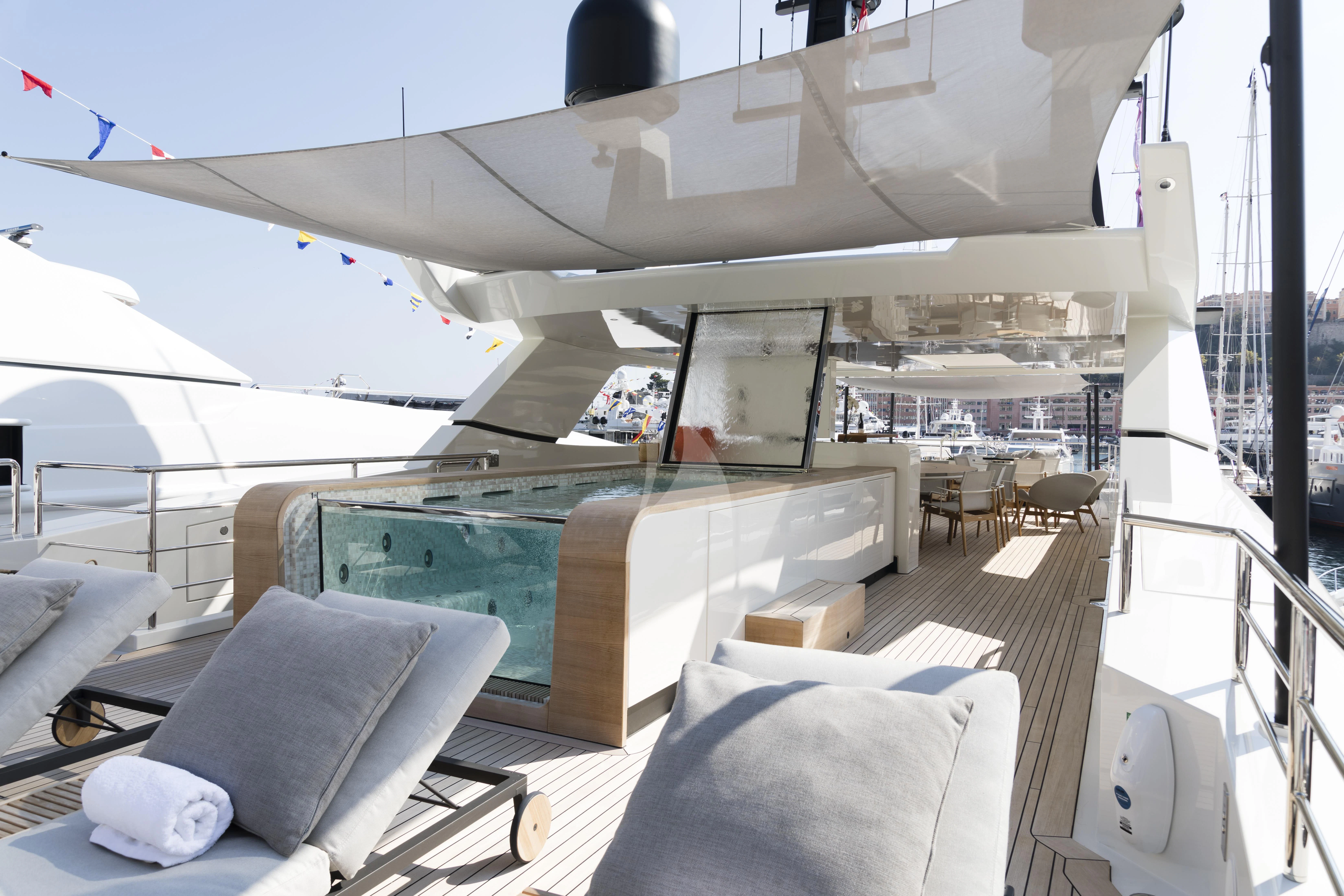 a large white boat with a large deck and a pool aboard ANDIAMO Yacht for Sale