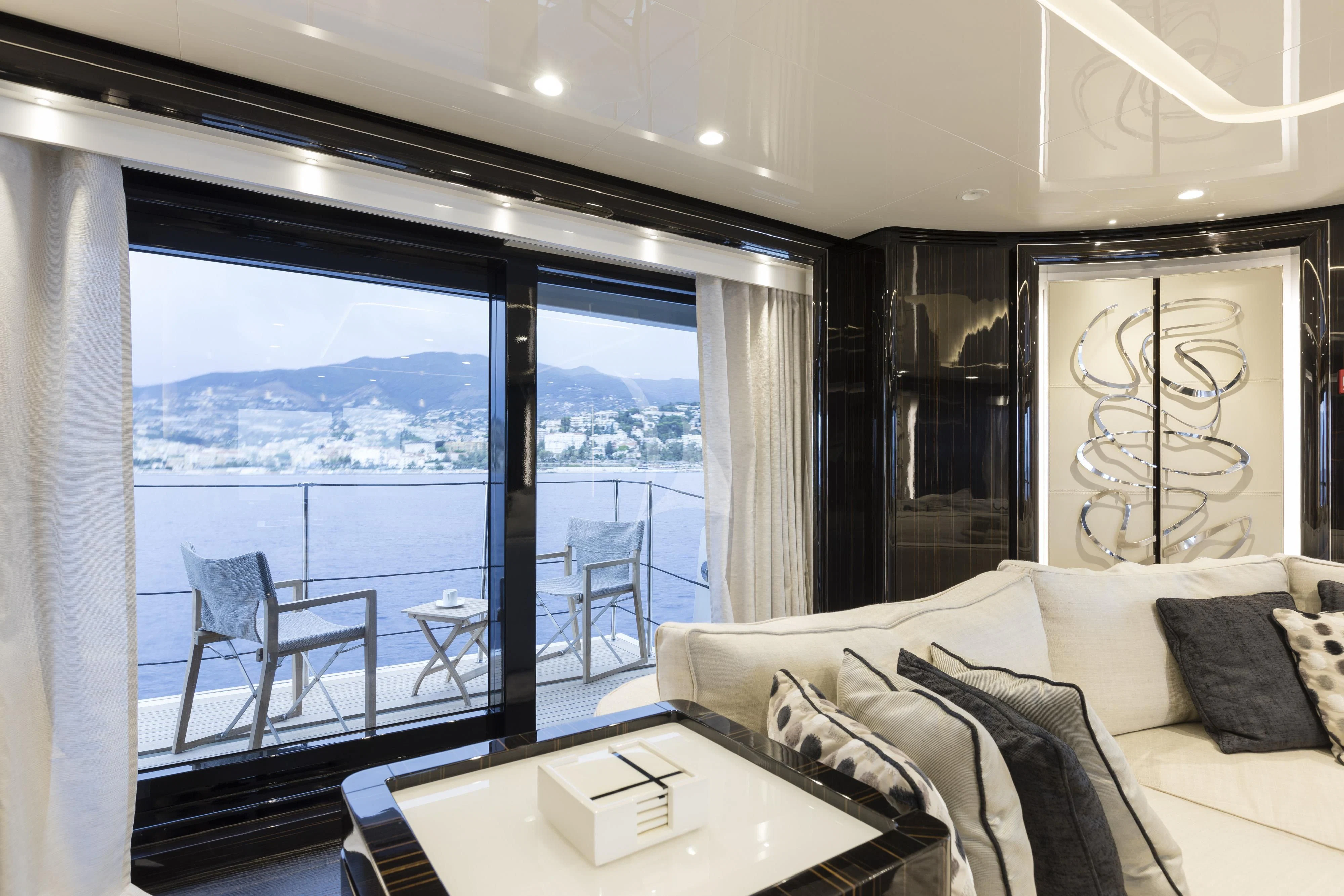 a room with a bed and a table and a window aboard ANDIAMO Yacht for Sale