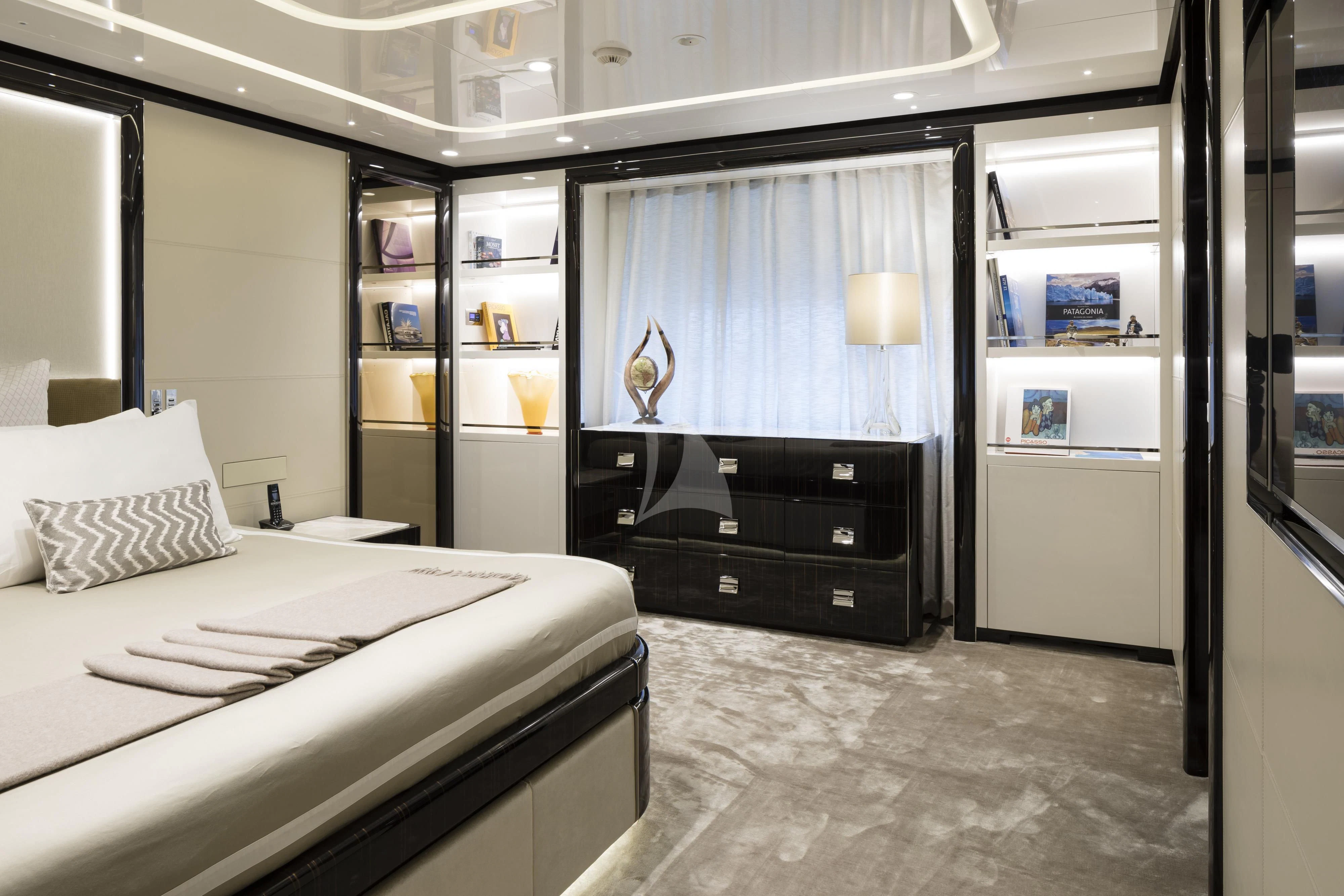 a room with a bed and a shelf with books aboard ANDIAMO Yacht for Sale