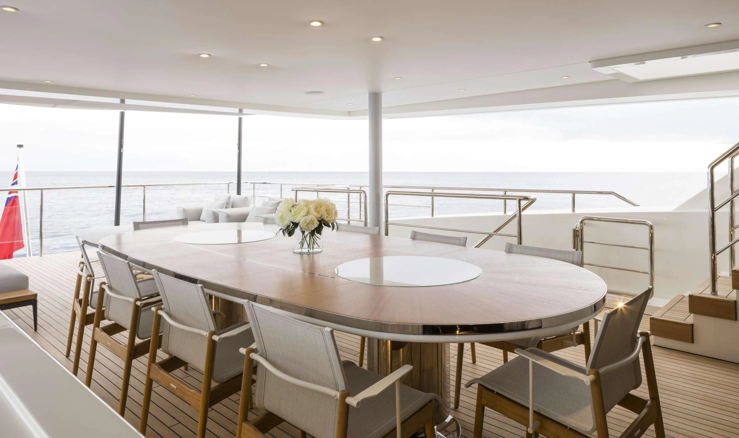 a room with tables and chairs aboard ANDIAMO Yacht for Sale