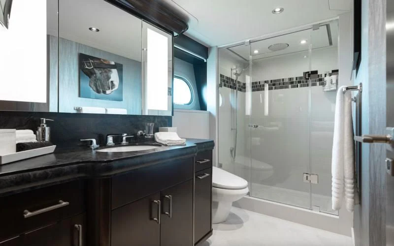 a bathroom with a glass shower aboard FIGARO Yacht for Sale