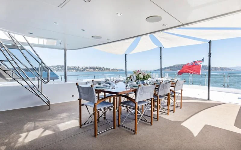 a table set up on a patio aboard FIGARO Yacht for Sale