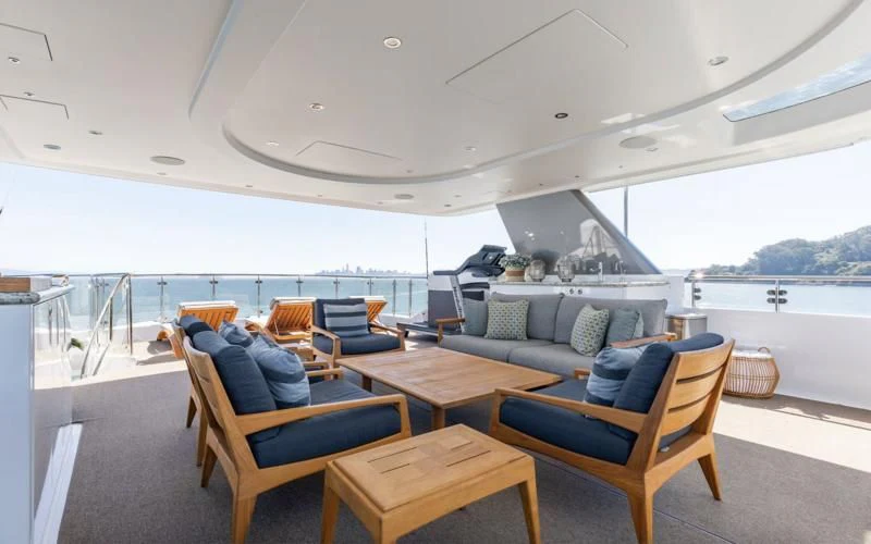 a living room with a couch and a table aboard FIGARO Yacht for Sale